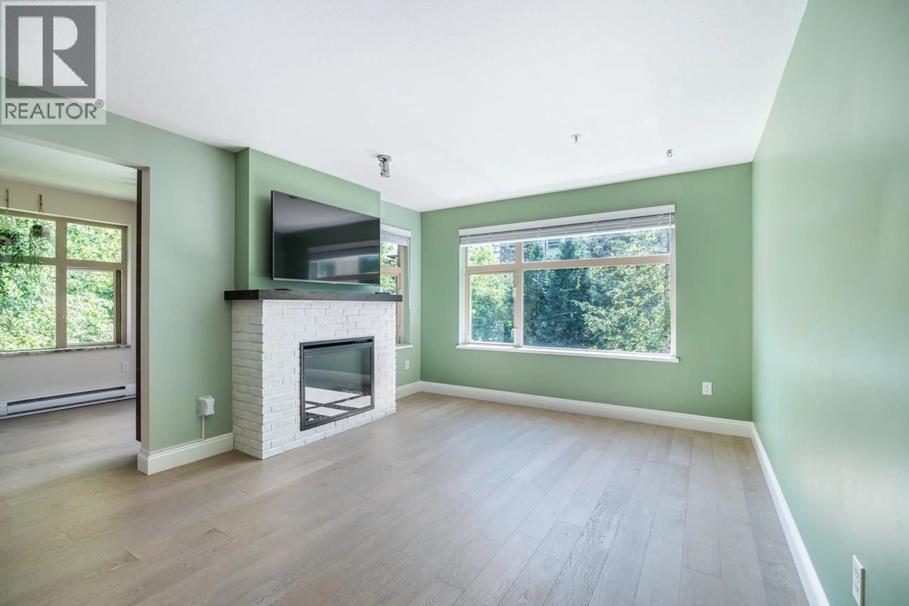 Living room with furniture, wood/laminate floor for 203 - 400 KLAHANIE DRIVE, Port Moody British Columbia V3H5K9