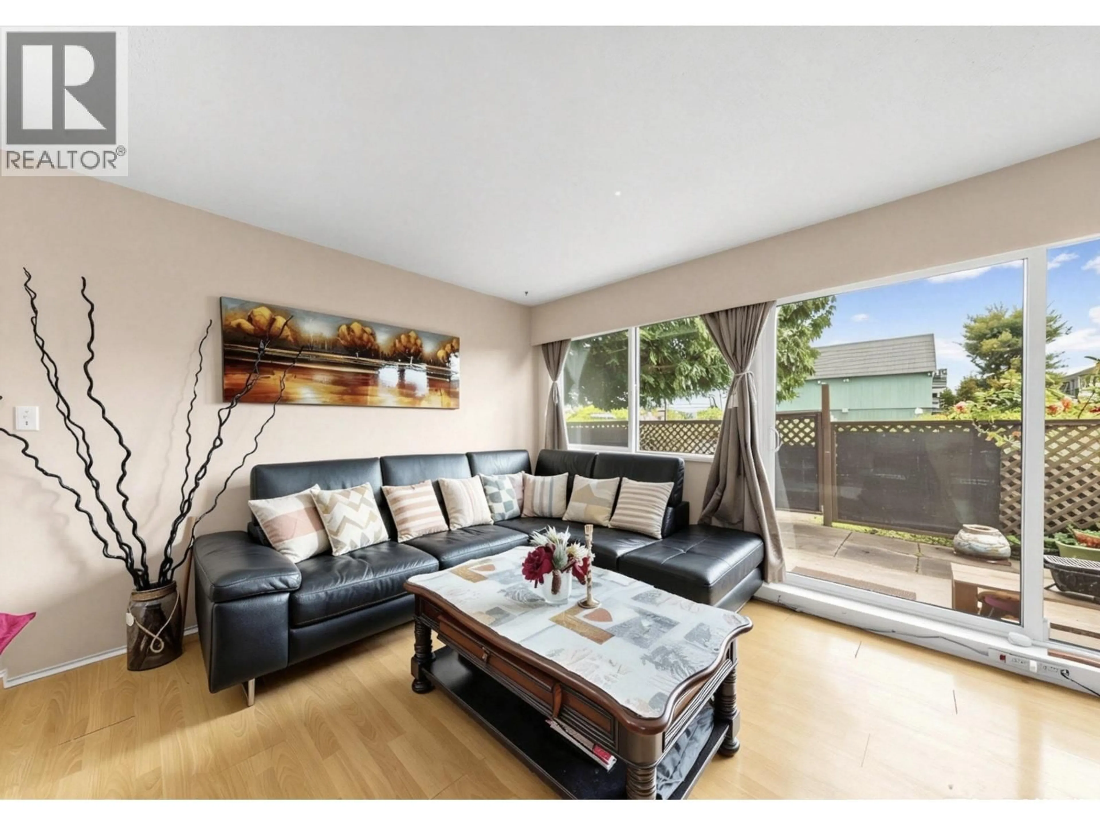 Living room with furniture, wood/laminate floor for 102 - 8020 RYAN ROAD, Richmond British Columbia V7A2E5