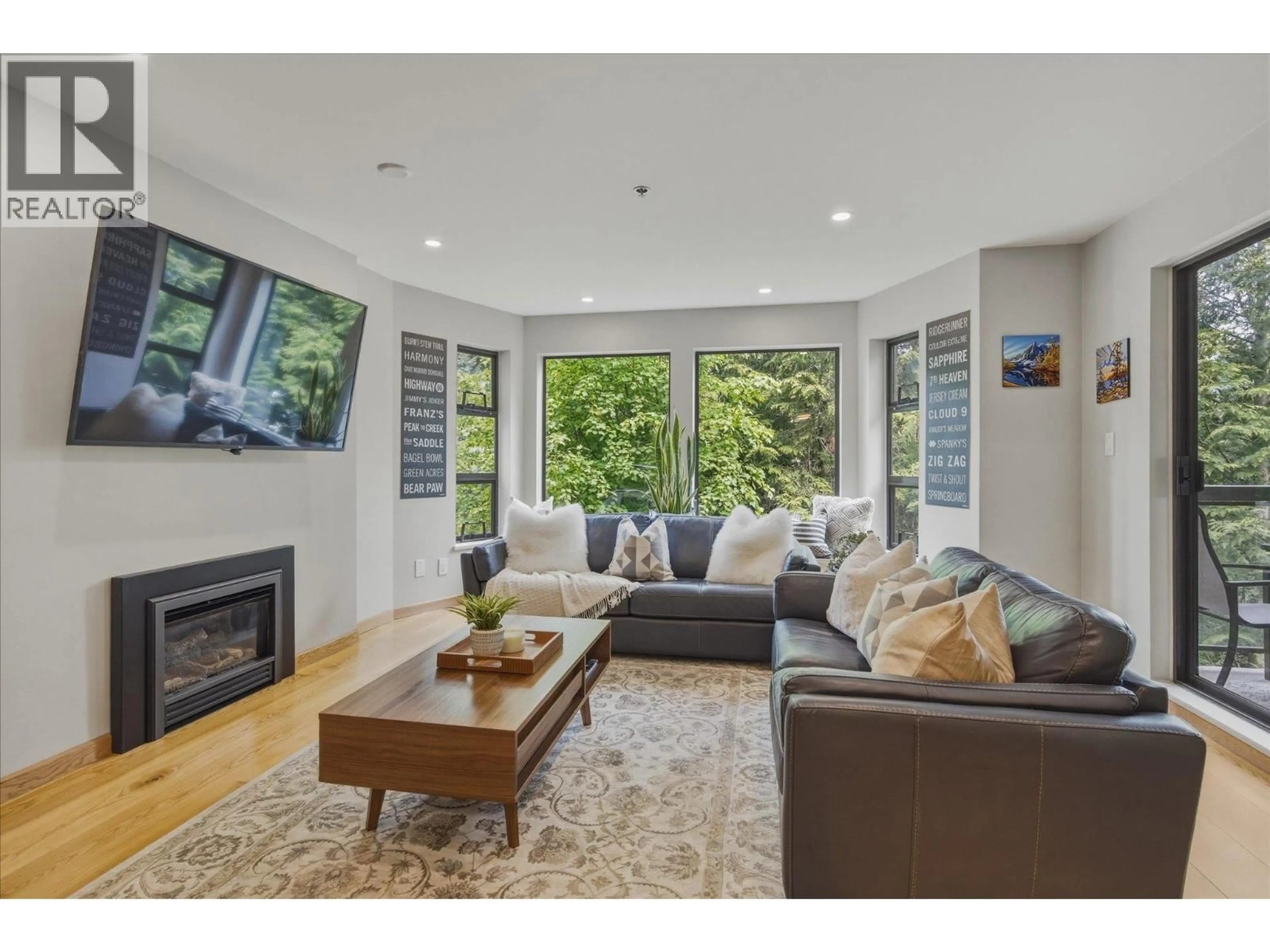 Living room with furniture, wood/laminate floor for 230 - 3309 PTARMIGAN PLACE, Whistler British Columbia V8E0V6