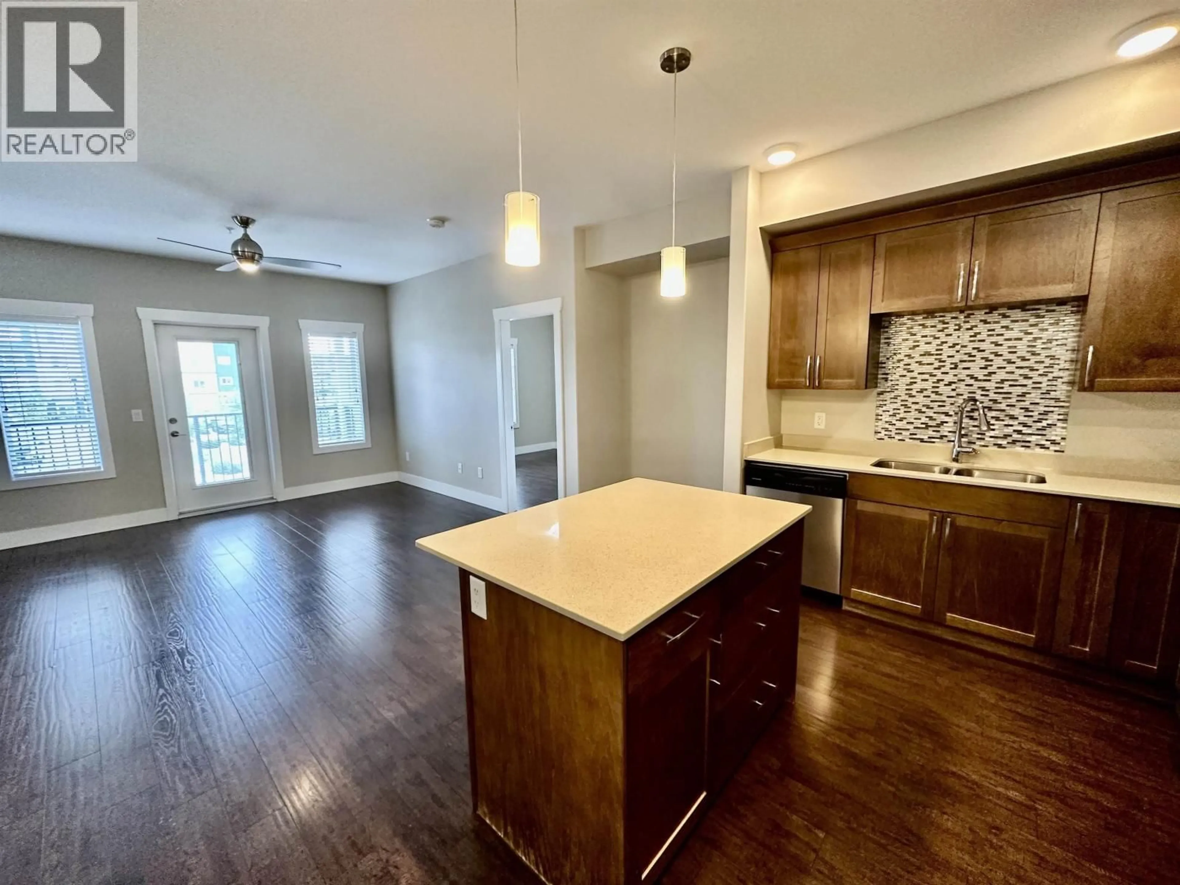 Open concept kitchen, wood/laminate floor for 212 - 11205 105 AVENUE, Fort St. John British Columbia V1J0L3