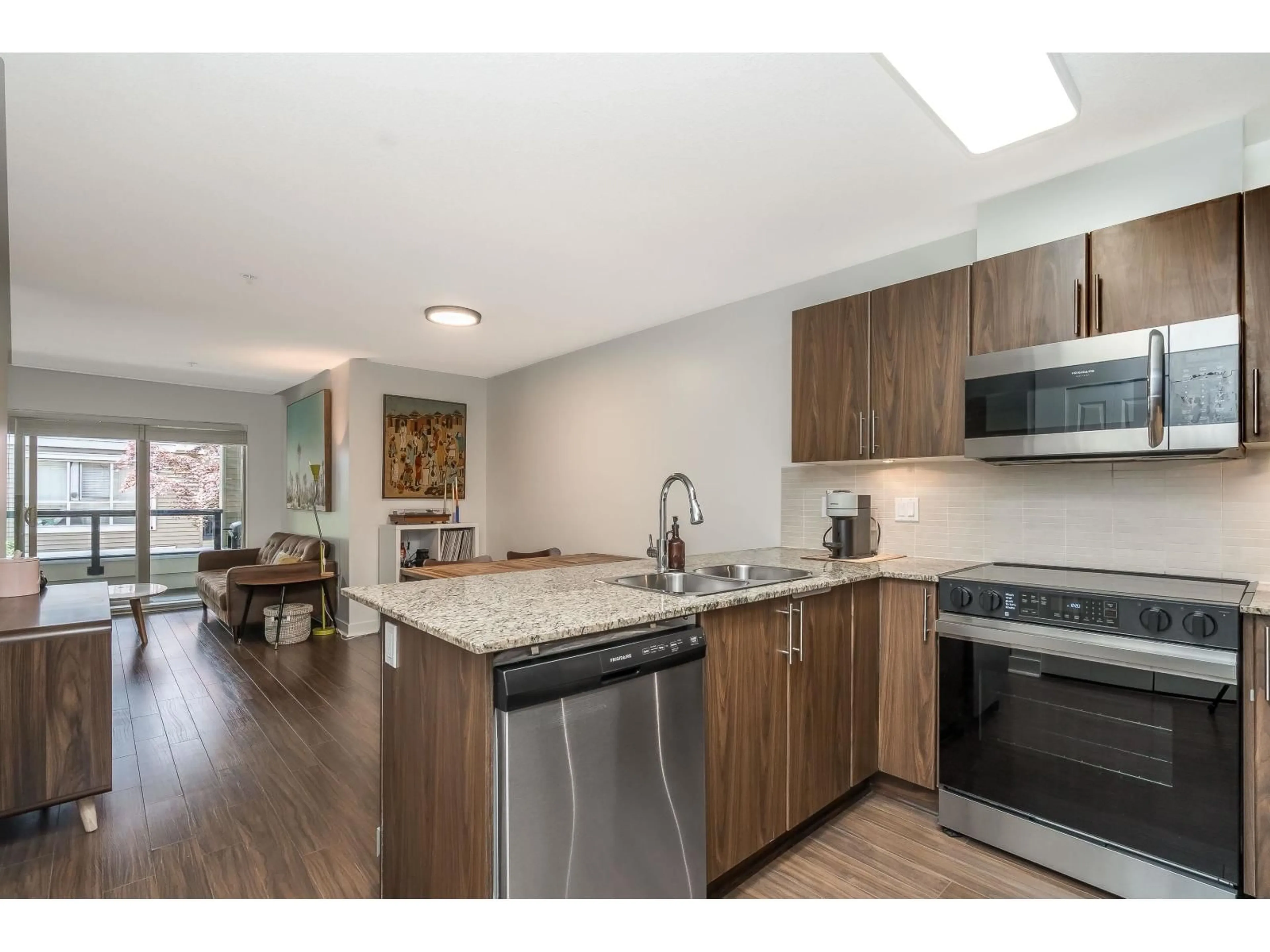 Open concept kitchen, wood/laminate floor for A218 - 8929 202 STREET, Langley British Columbia V1M0B4
