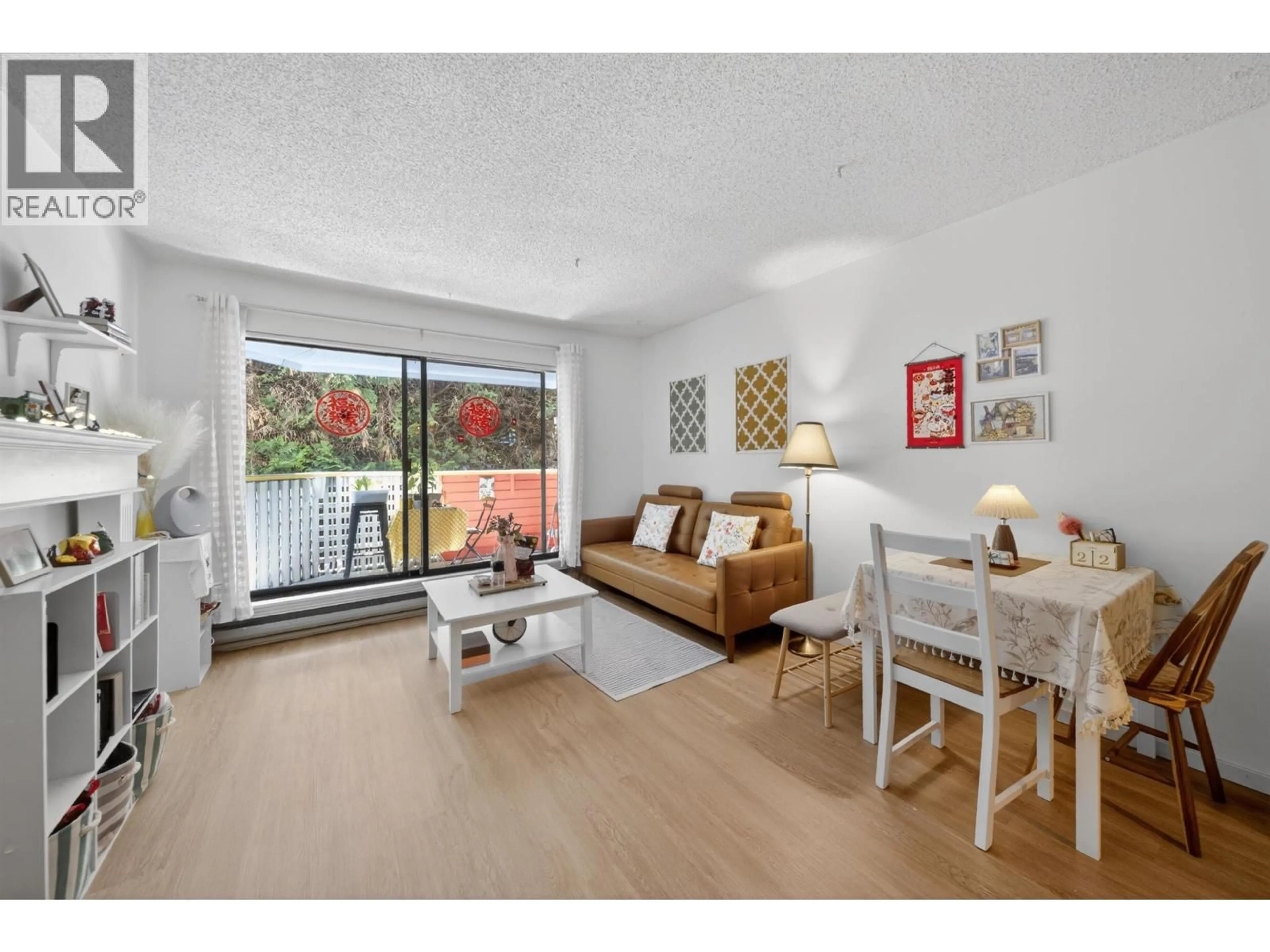 Living room with furniture, wood/laminate floor for 105 - 8700 ACKROYD ROAD, Richmond British Columbia V6X3G2