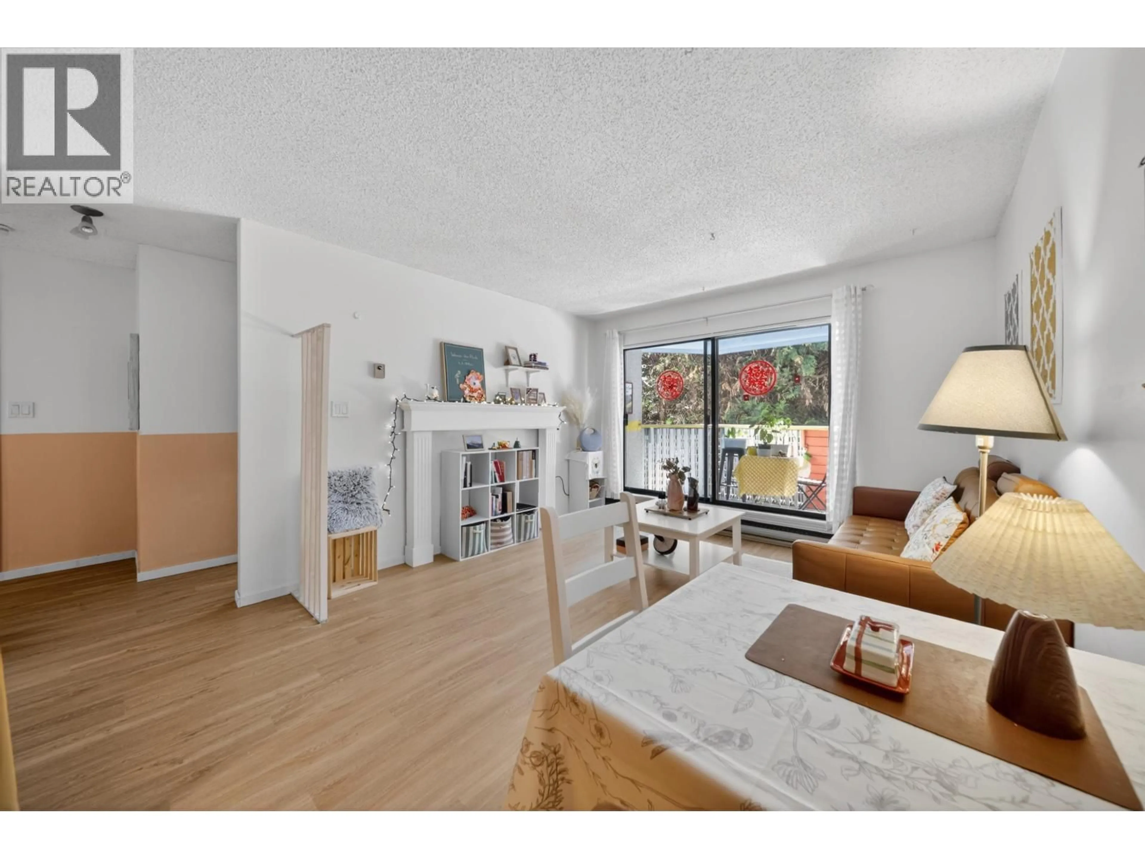 Living room with furniture, wood/laminate floor for 105 - 8700 ACKROYD ROAD, Richmond British Columbia V6X3G2