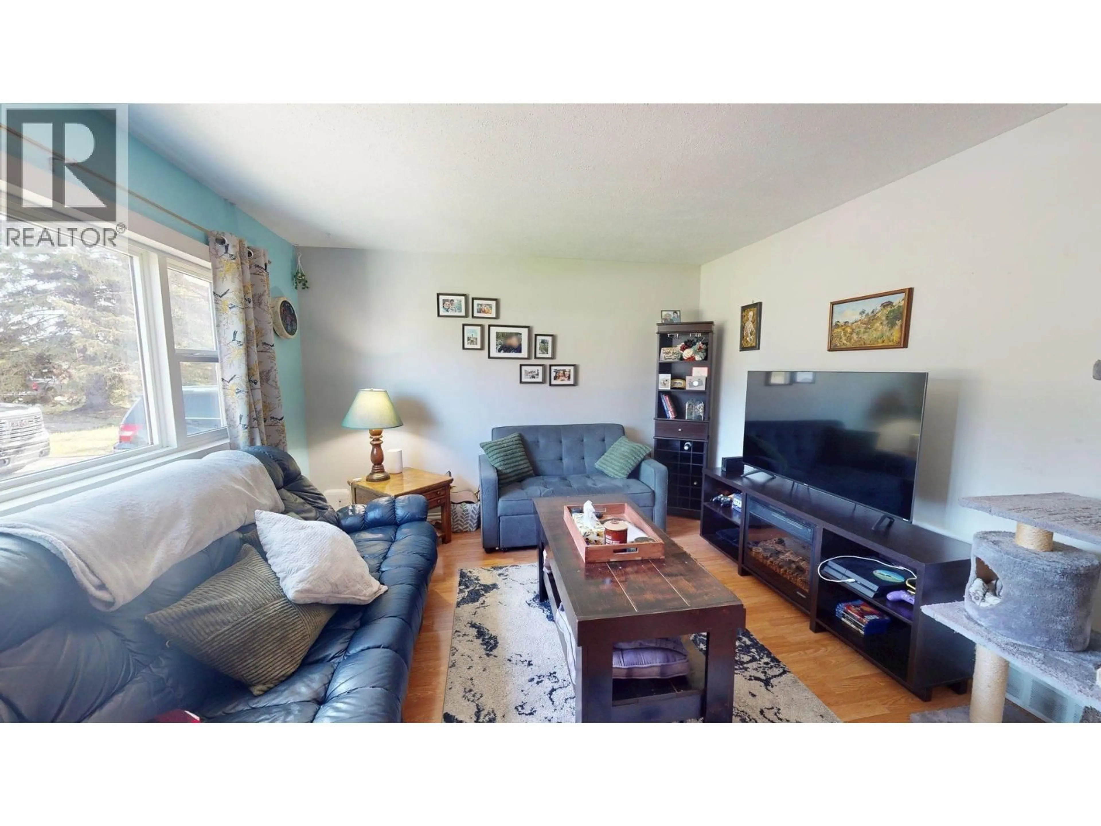 Living room with furniture, wood/laminate floor for 9711 106 AVENUE, Fort St. John British Columbia V1J2N6