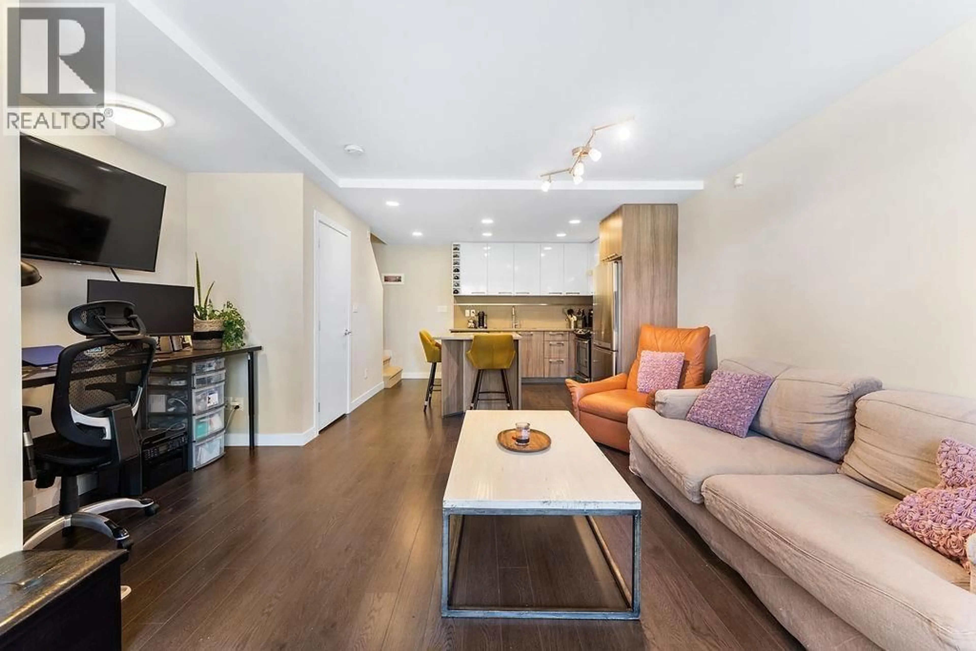 Living room with furniture, wood/laminate floor for 104 - 9350 UNIVERSITY HIGH STREET, Burnaby British Columbia V5A0B6
