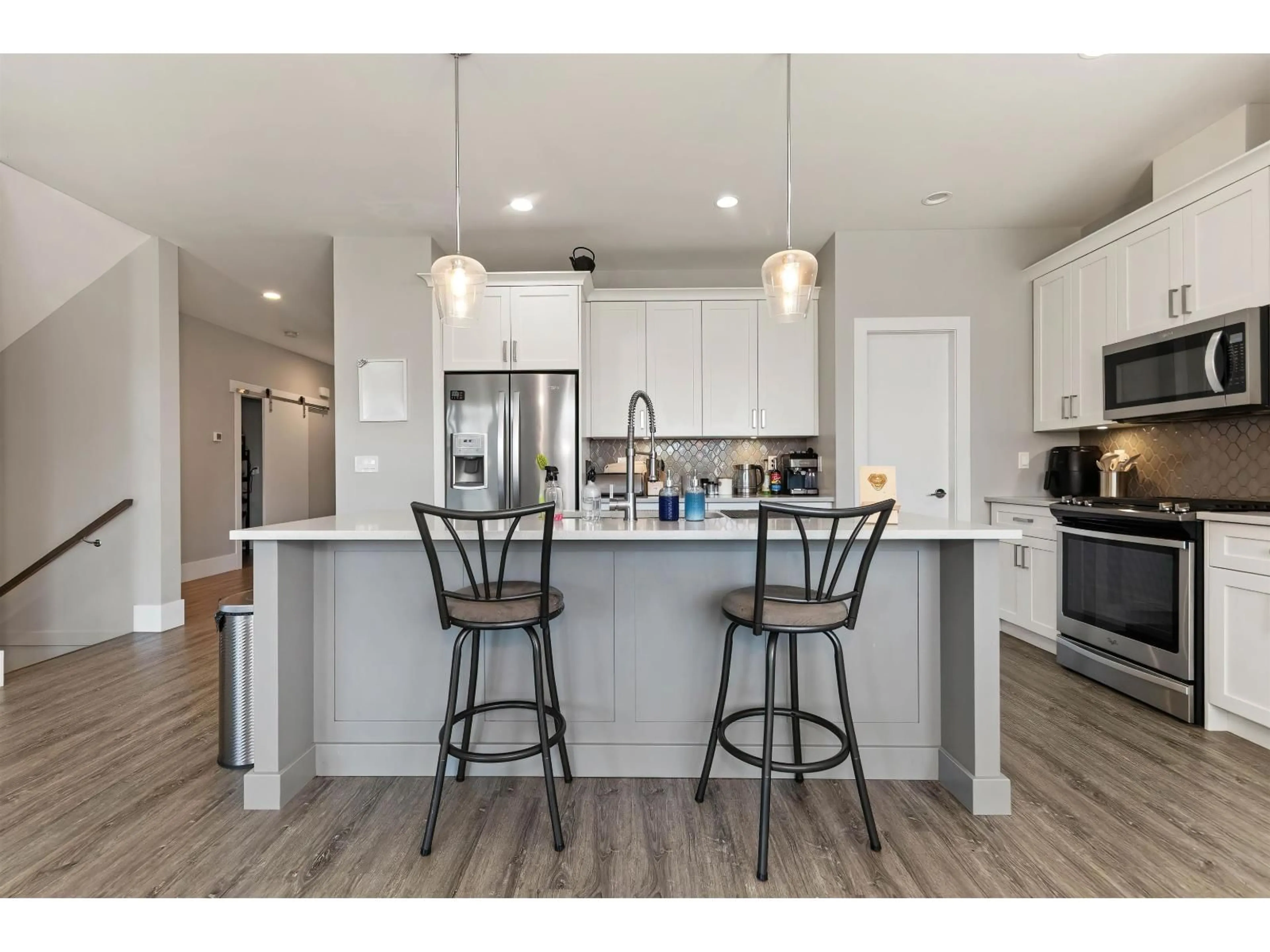Open concept kitchen, wood/laminate floor for 6567 FERN STREET, Chilliwack British Columbia V2R2Z7