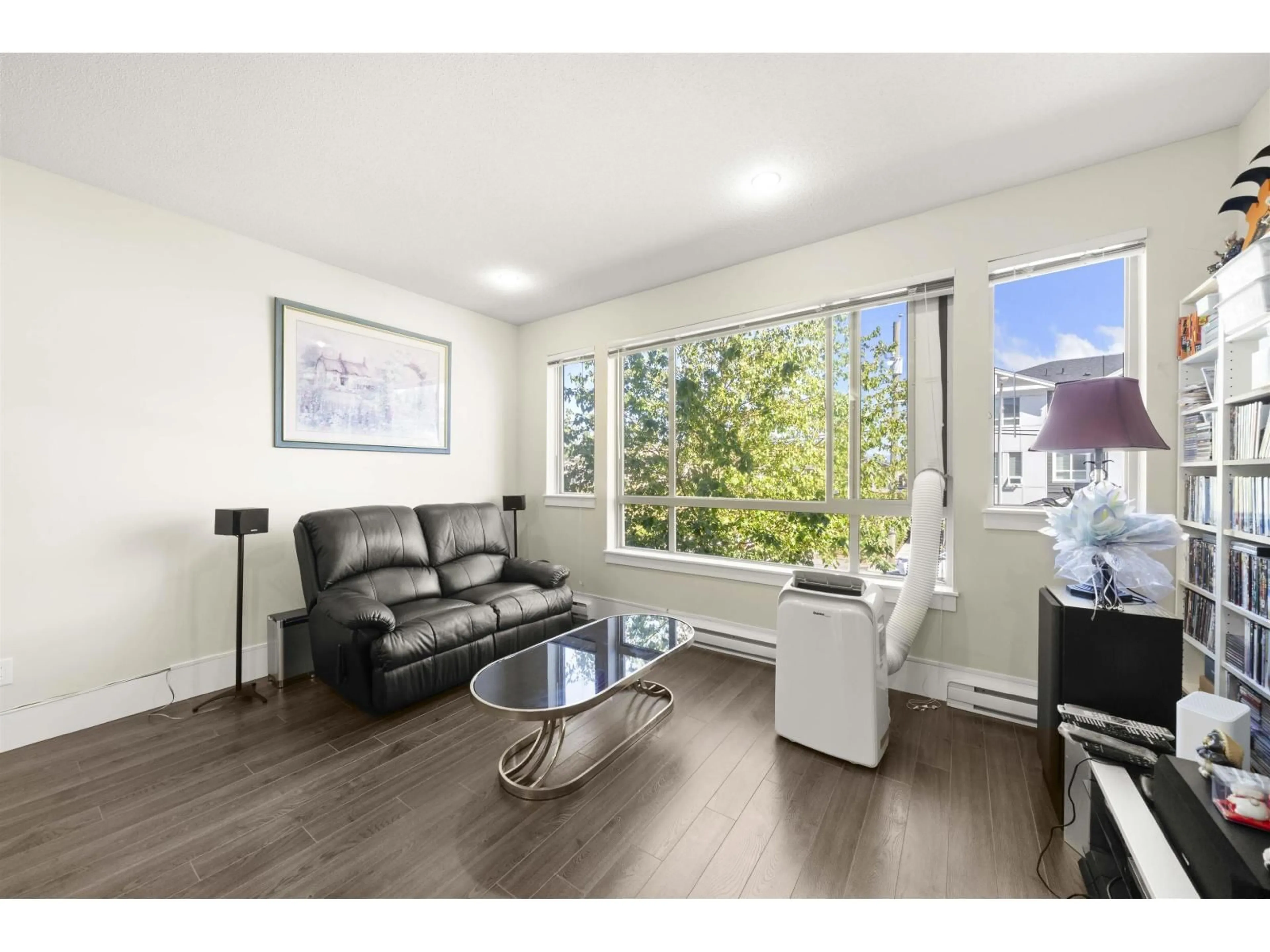 Living room with furniture, wood/laminate floor for 4 - 19752 55A AVENUE, Langley British Columbia V3A3X2