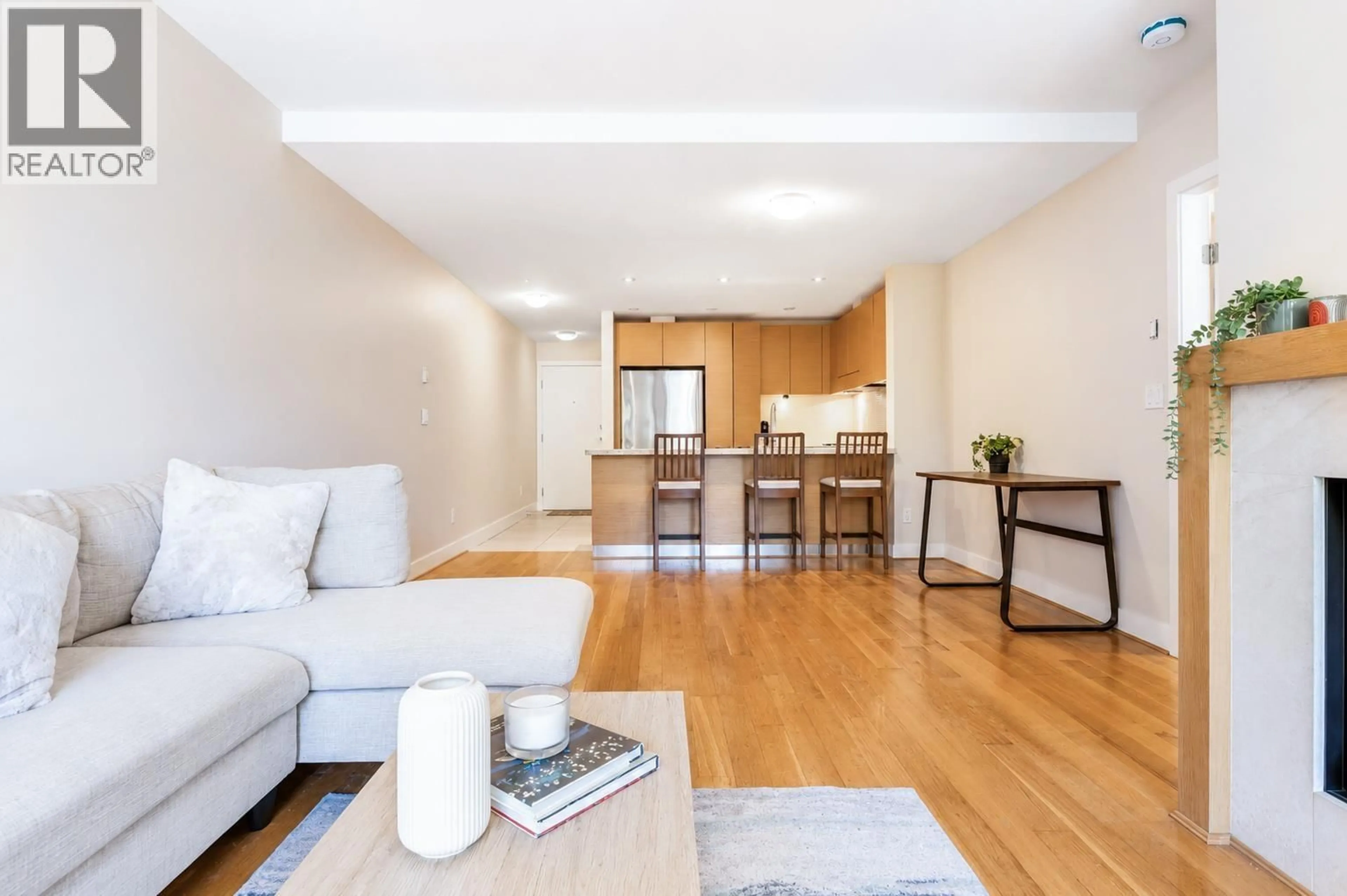 Living room with furniture, wood/laminate floor for 107 - 6015 IONA DRIVE, Vancouver British Columbia V6T2J4