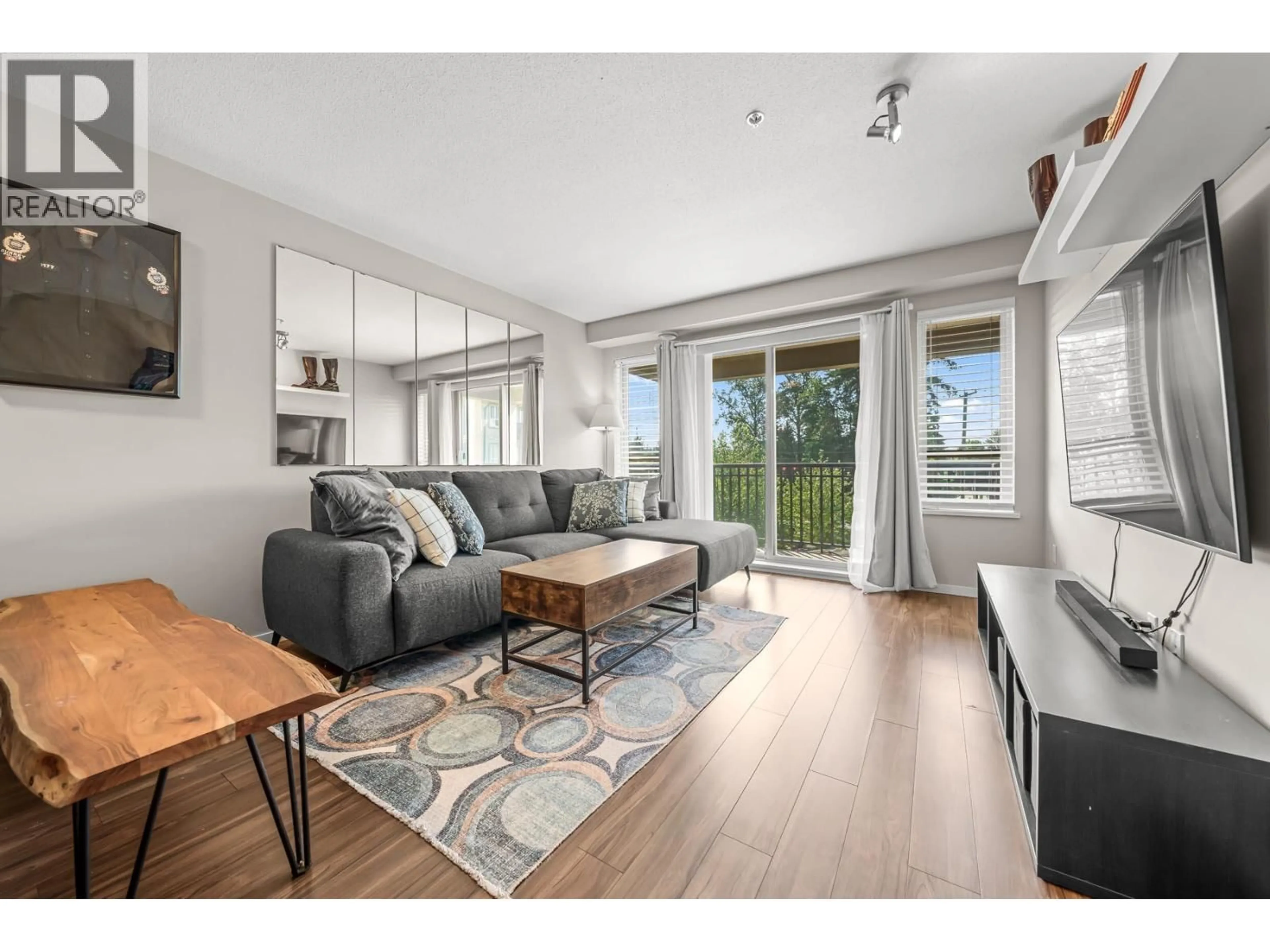 Living room with furniture, wood/laminate floor for 307 - 3178 DAYANEE SPRINGS BOULEVARD, Coquitlam British Columbia V3E0B9