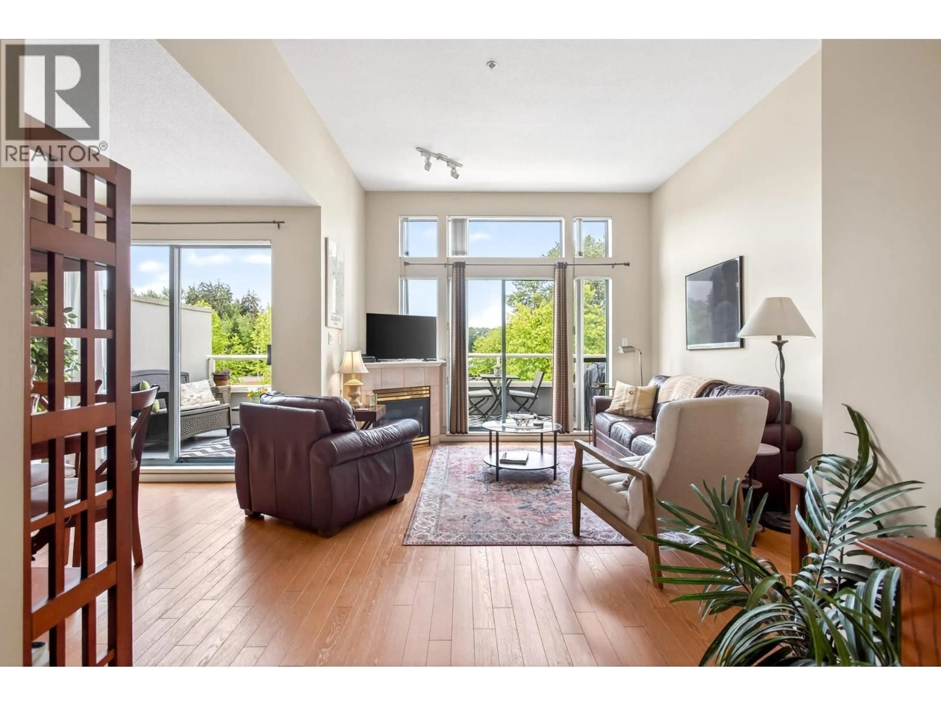 Living room with furniture, wood/laminate floor for 409 - 220 NEWPORT DRIVE, Port Moody British Columbia V3H5B8