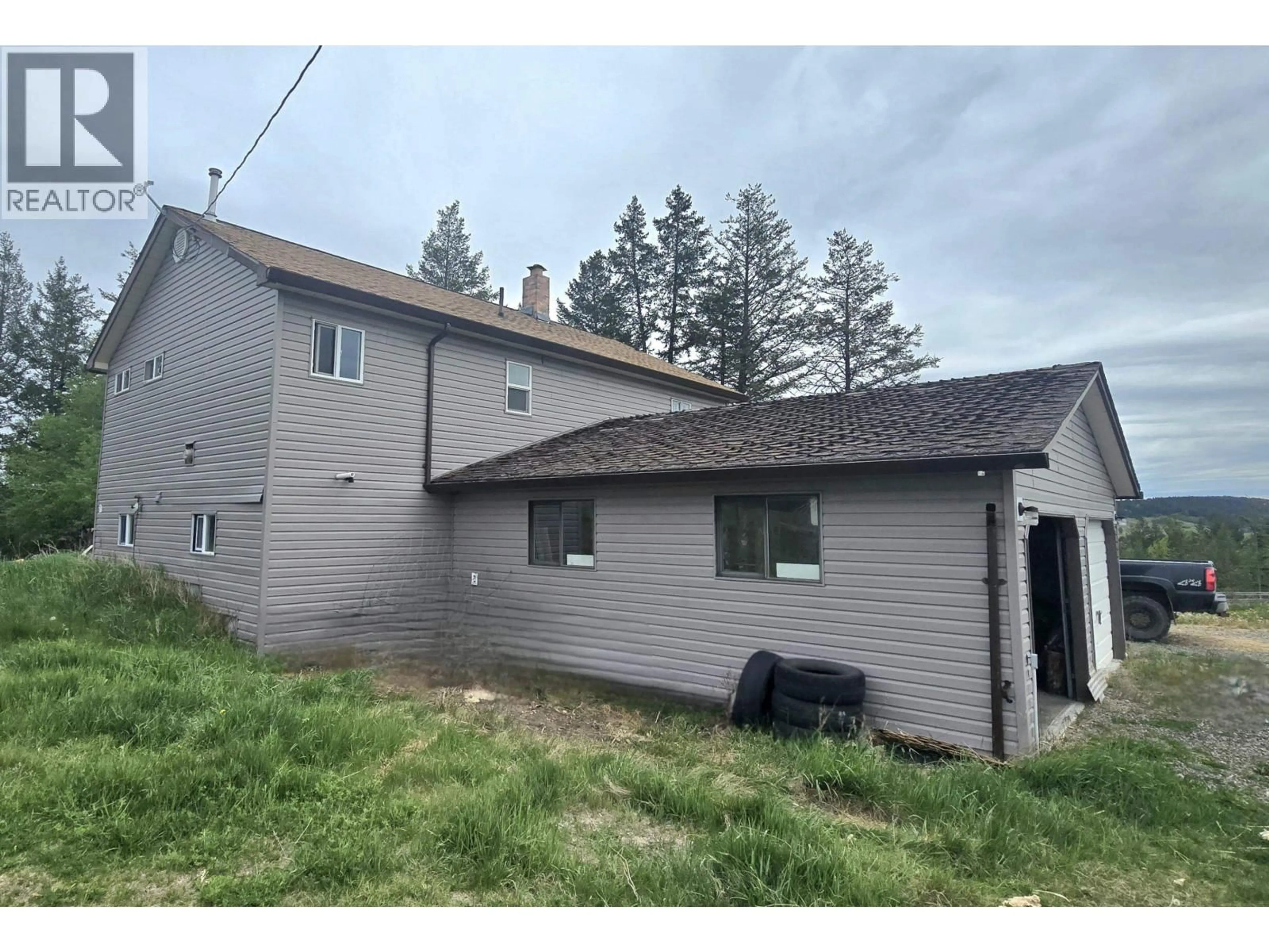 A pic from outside/outdoor area/front of a property/back of a property/a pic from drone, building for 5437 TATTON STATION ROAD, 100 Mile House British Columbia V0K2E1
