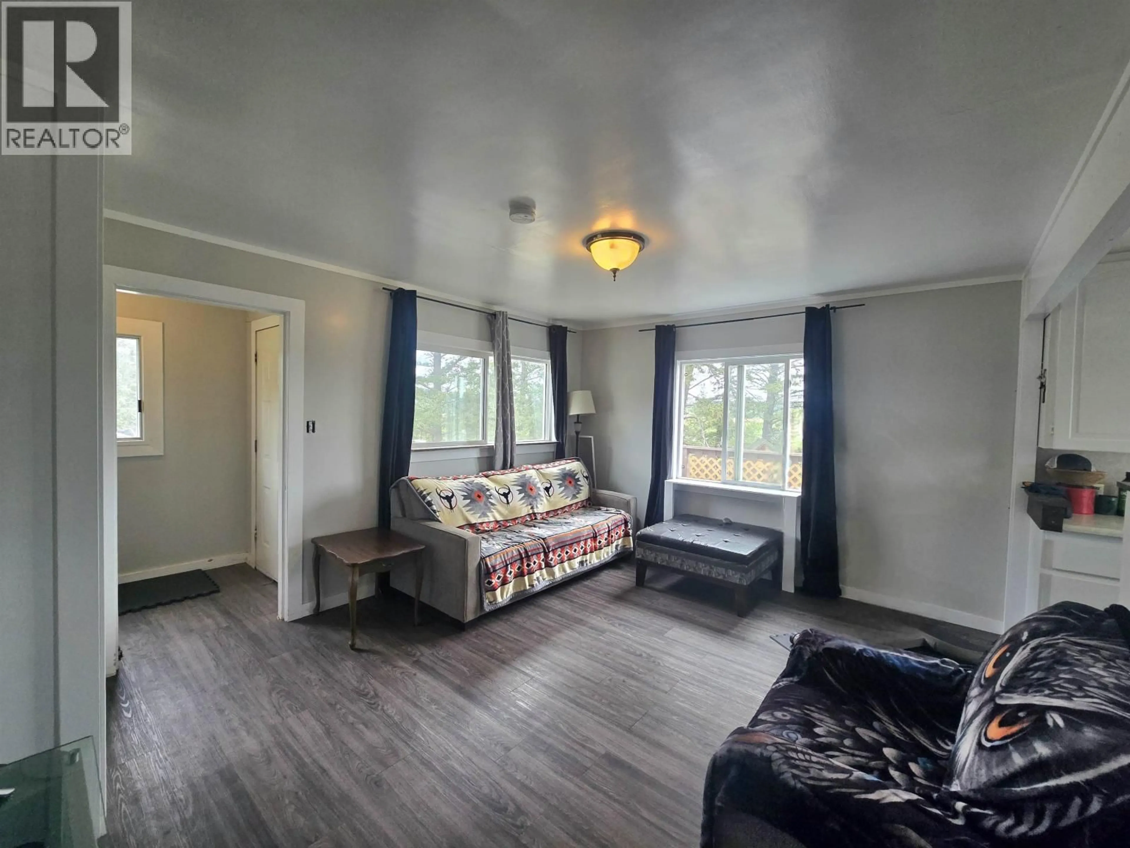 Living room with furniture, wood/laminate floor for 5437 TATTON STATION ROAD, 100 Mile House British Columbia V0K2E1