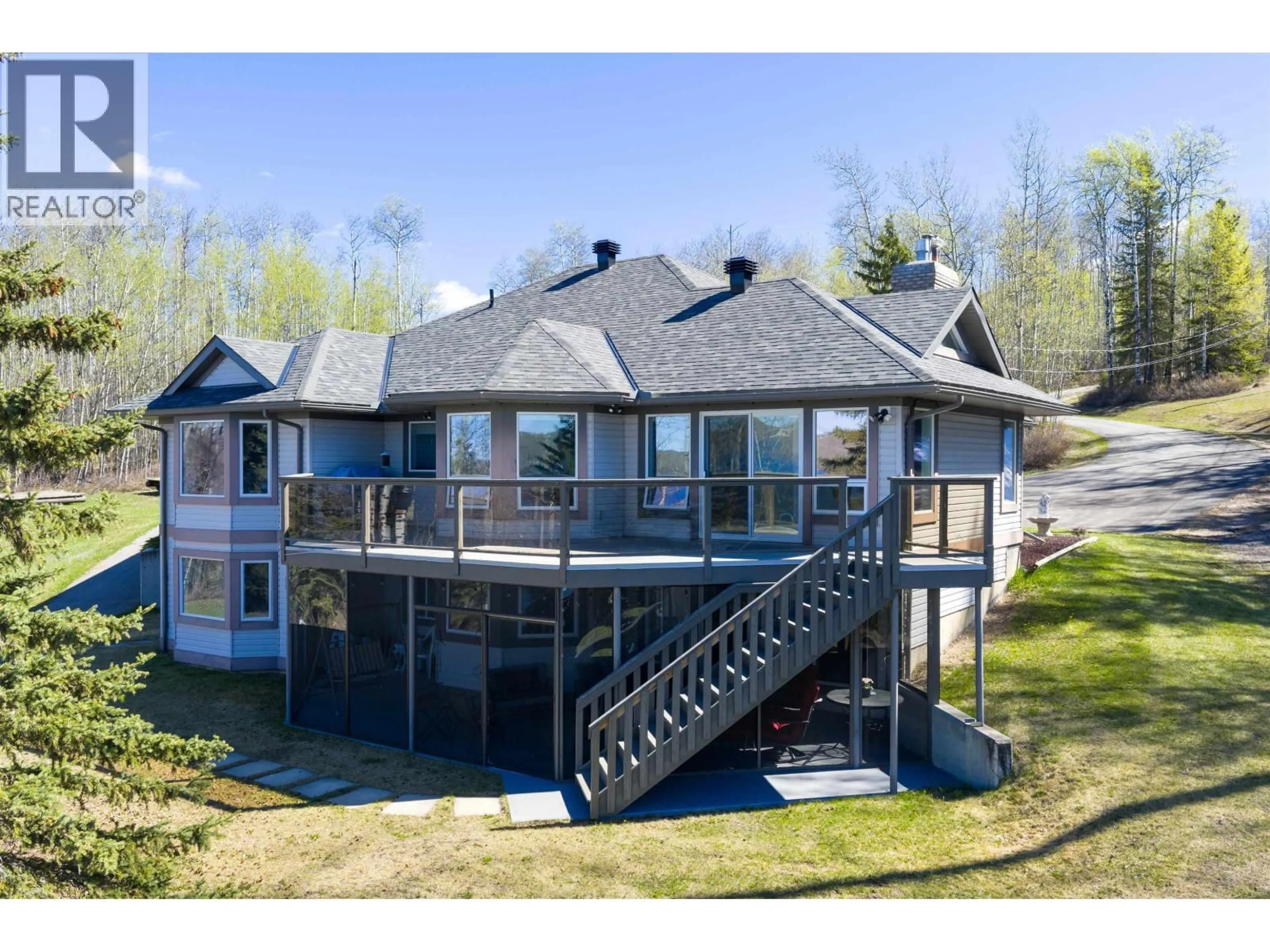 A pic from outside/outdoor area/front of a property/back of a property/a pic from drone, water/lake/river/ocean view for 13499 SUNNYSIDE COVE, Charlie Lake British Columbia V0C1H0