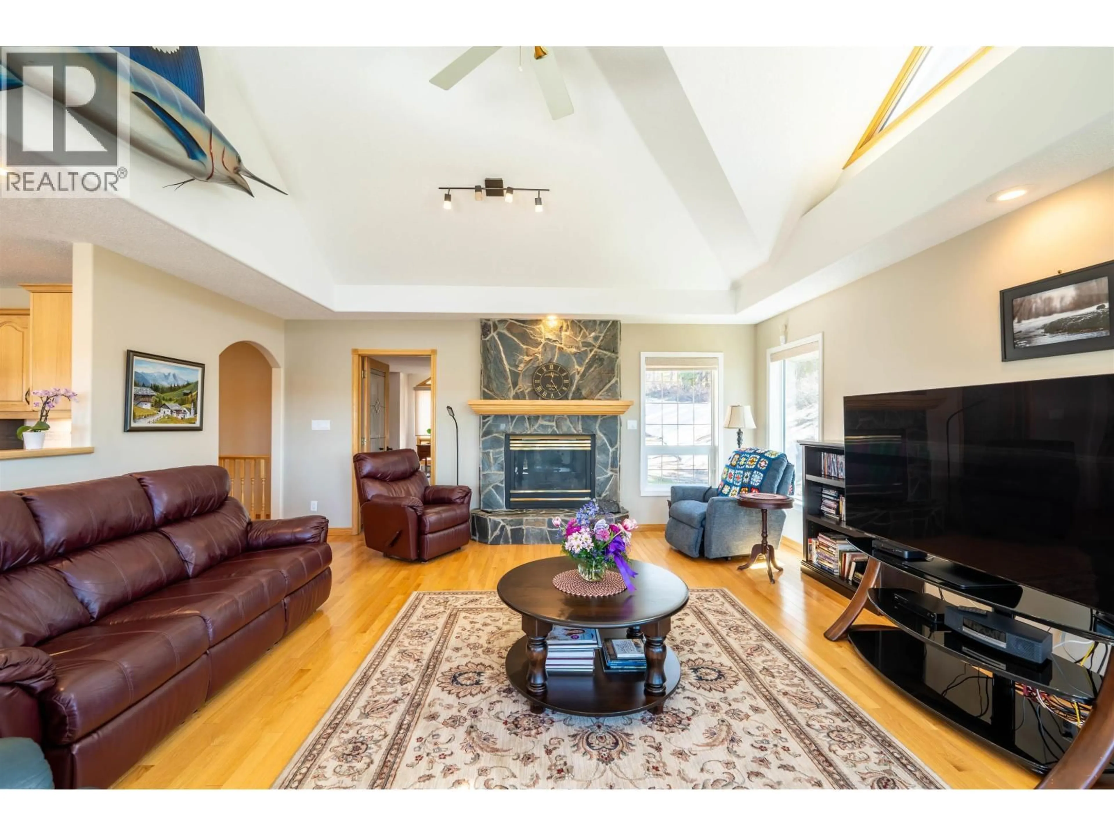 Living room with furniture, wood/laminate floor for 13499 SUNNYSIDE COVE, Charlie Lake British Columbia V0C1H0