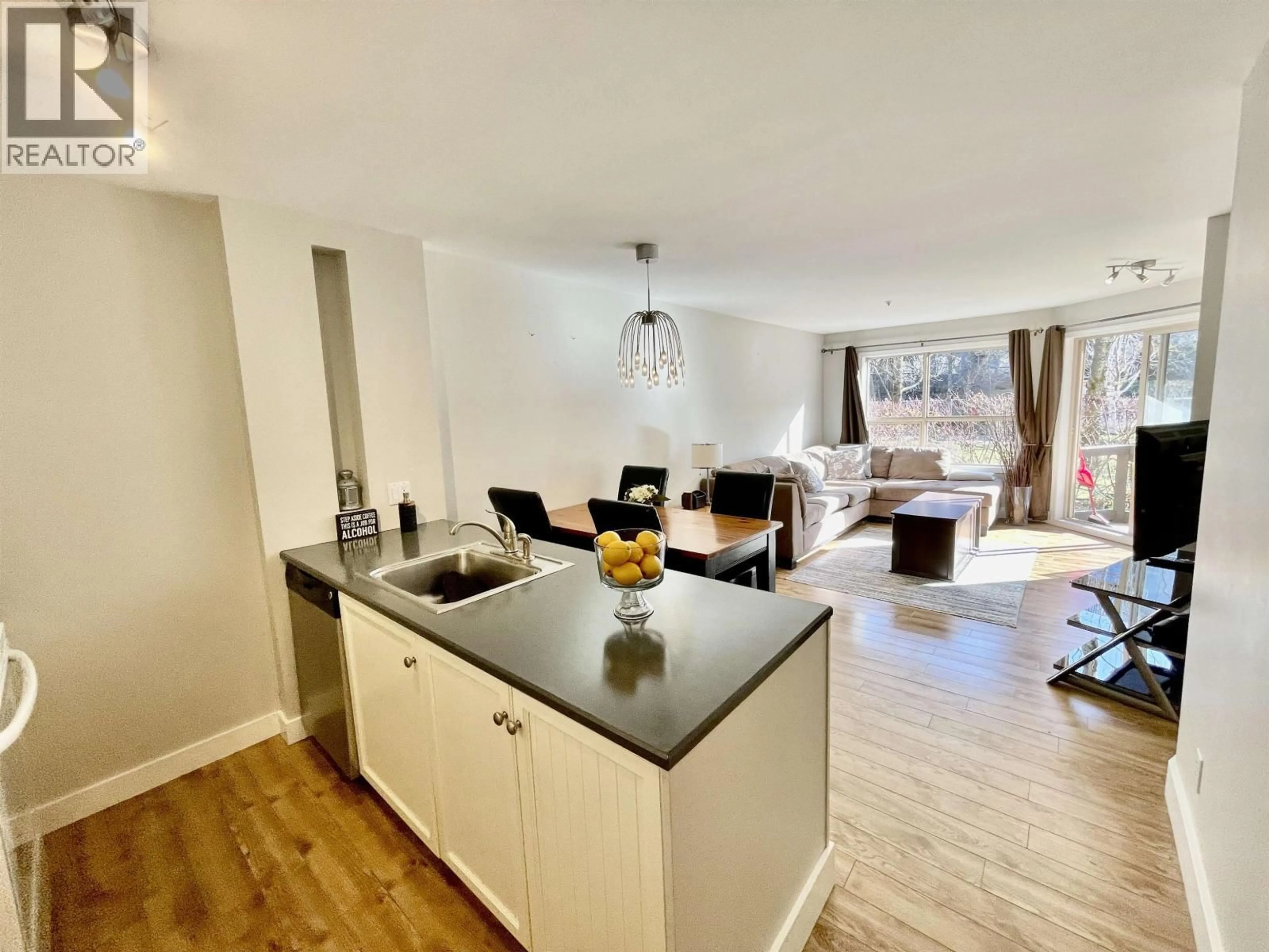 Open concept kitchen, wood/laminate floor for 103 - 4800 SPEARHEAD DRIVE, Whistler British Columbia V8E1G1