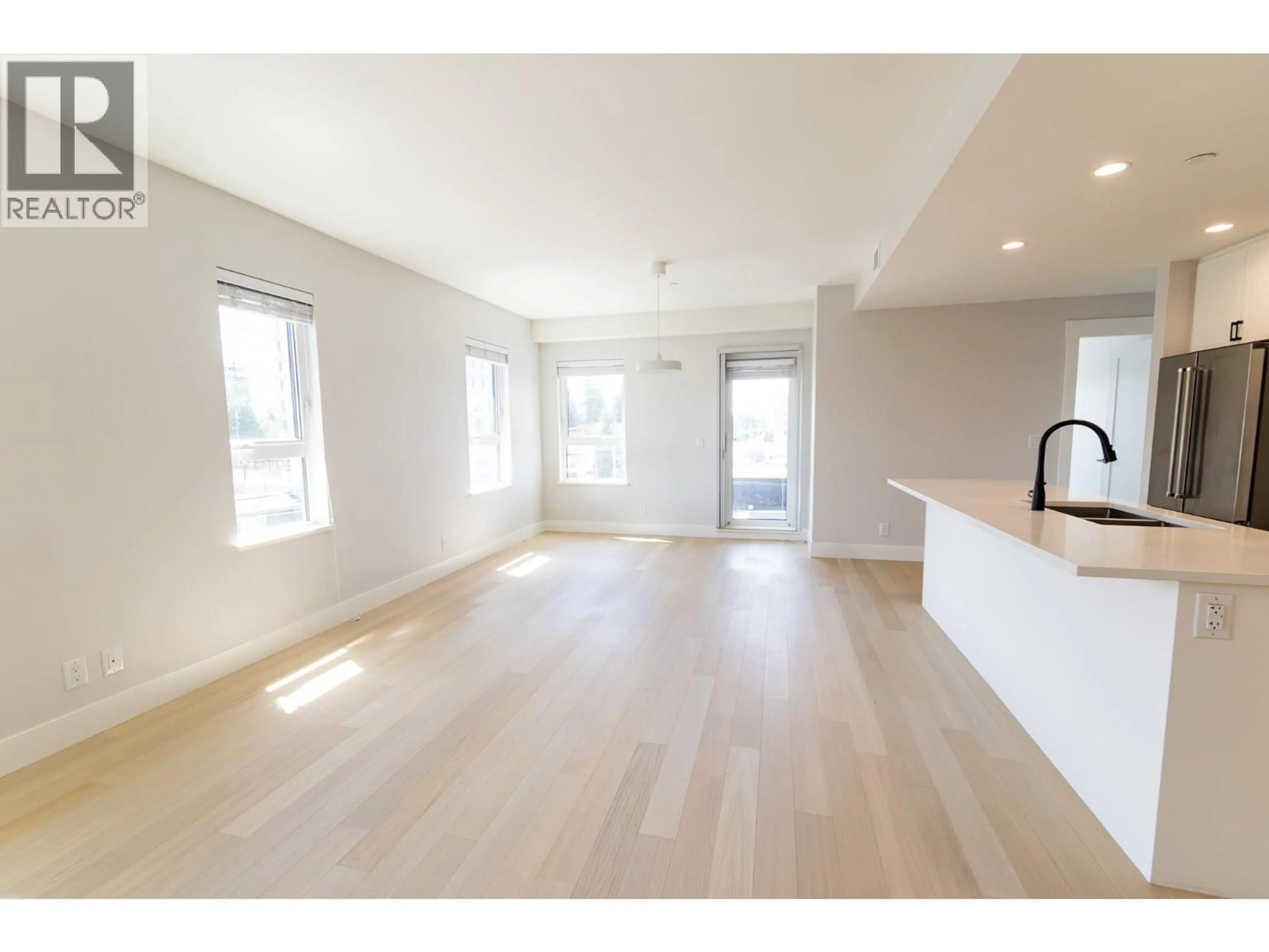 Open concept kitchen, wood/laminate floor for 402 - 22265 DEWDNEY TRUNK ROAD, Maple Ridge British Columbia V2X3J1