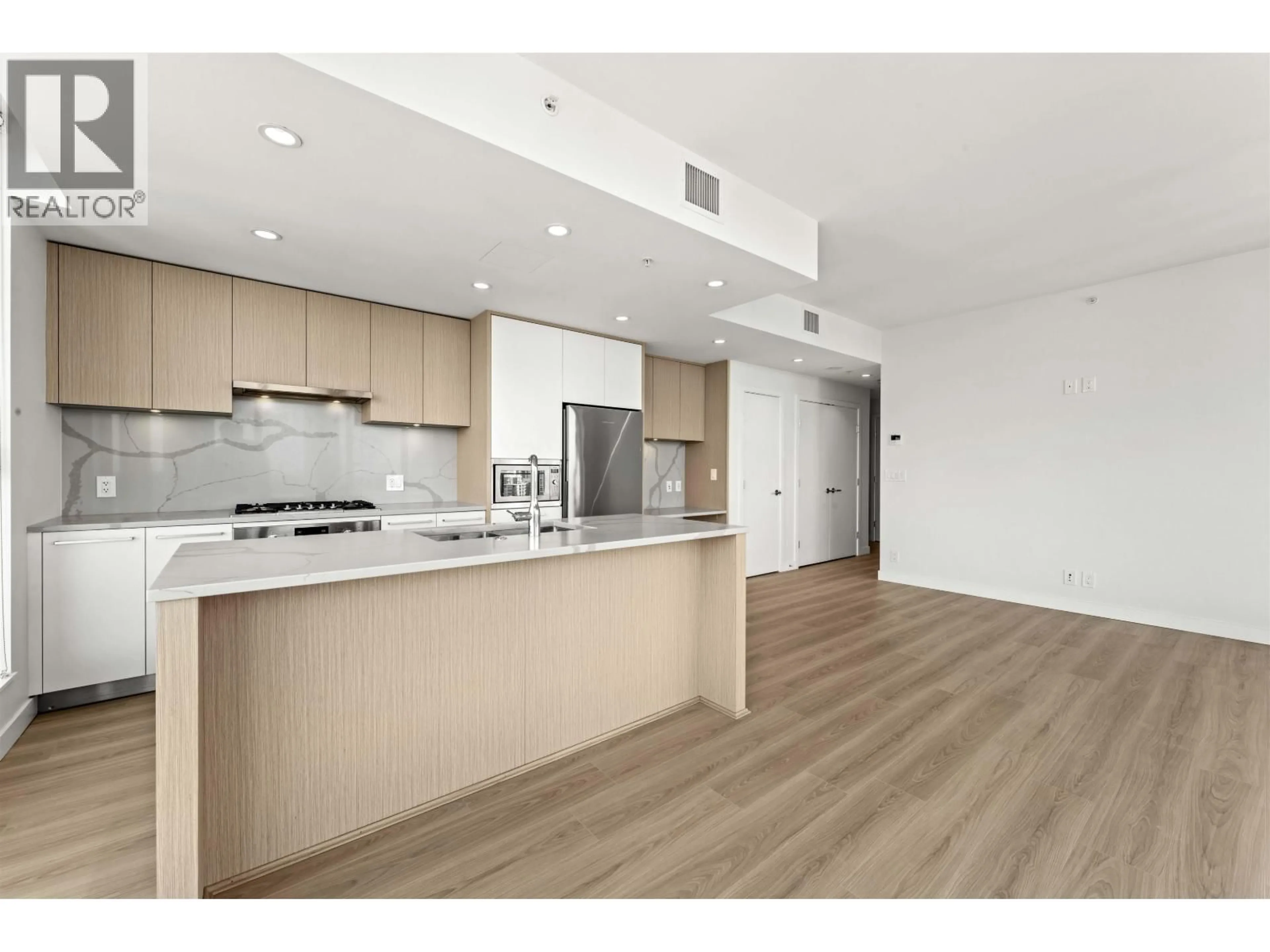 Open concept kitchen, wood/laminate floor for 2901 - 567 CLARKE ROAD, Coquitlam British Columbia V3J0K7