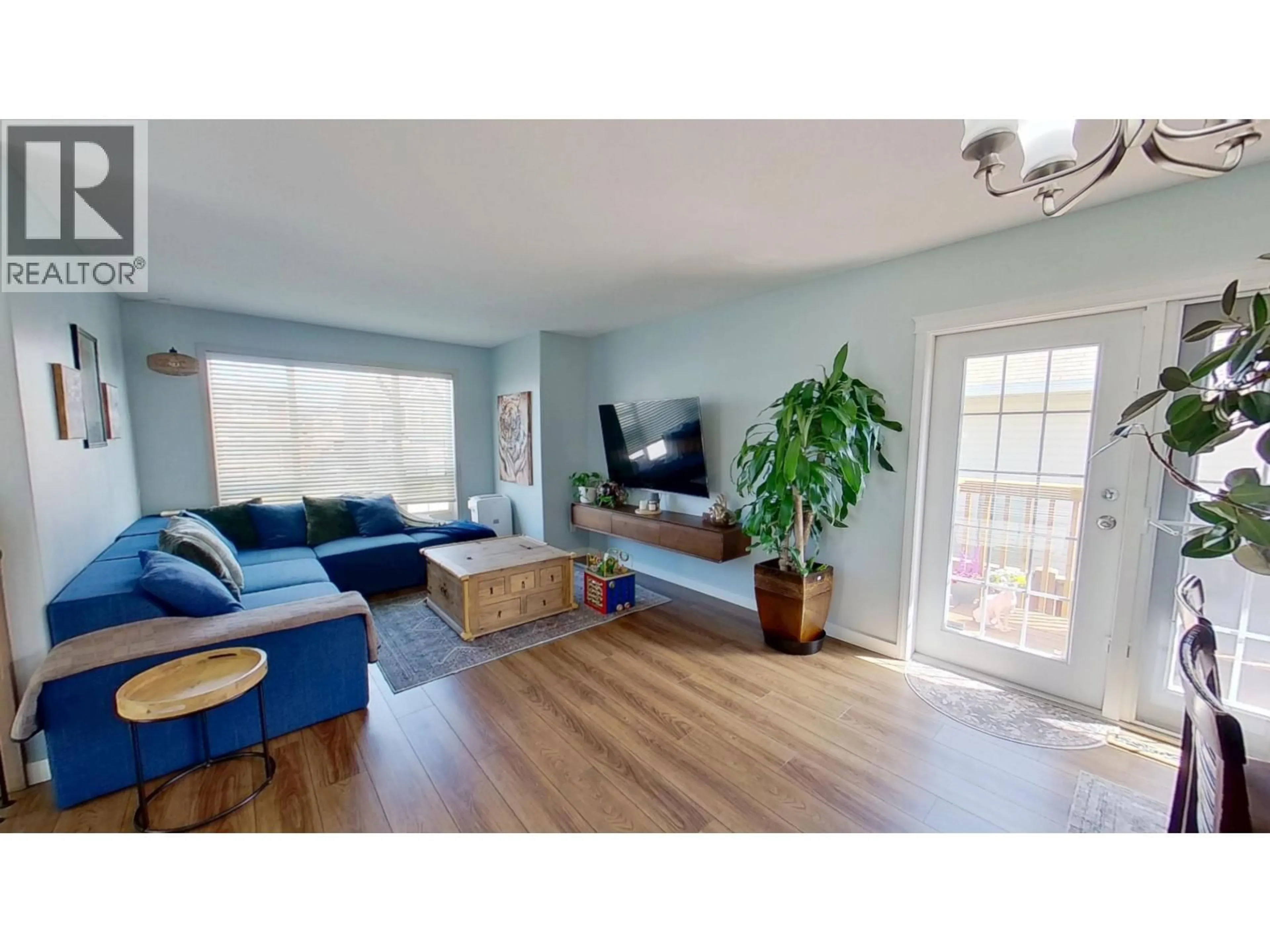 Living room with furniture, wood/laminate floor for 8311 86 AVENUE, Fort St. John British Columbia V1J0G4