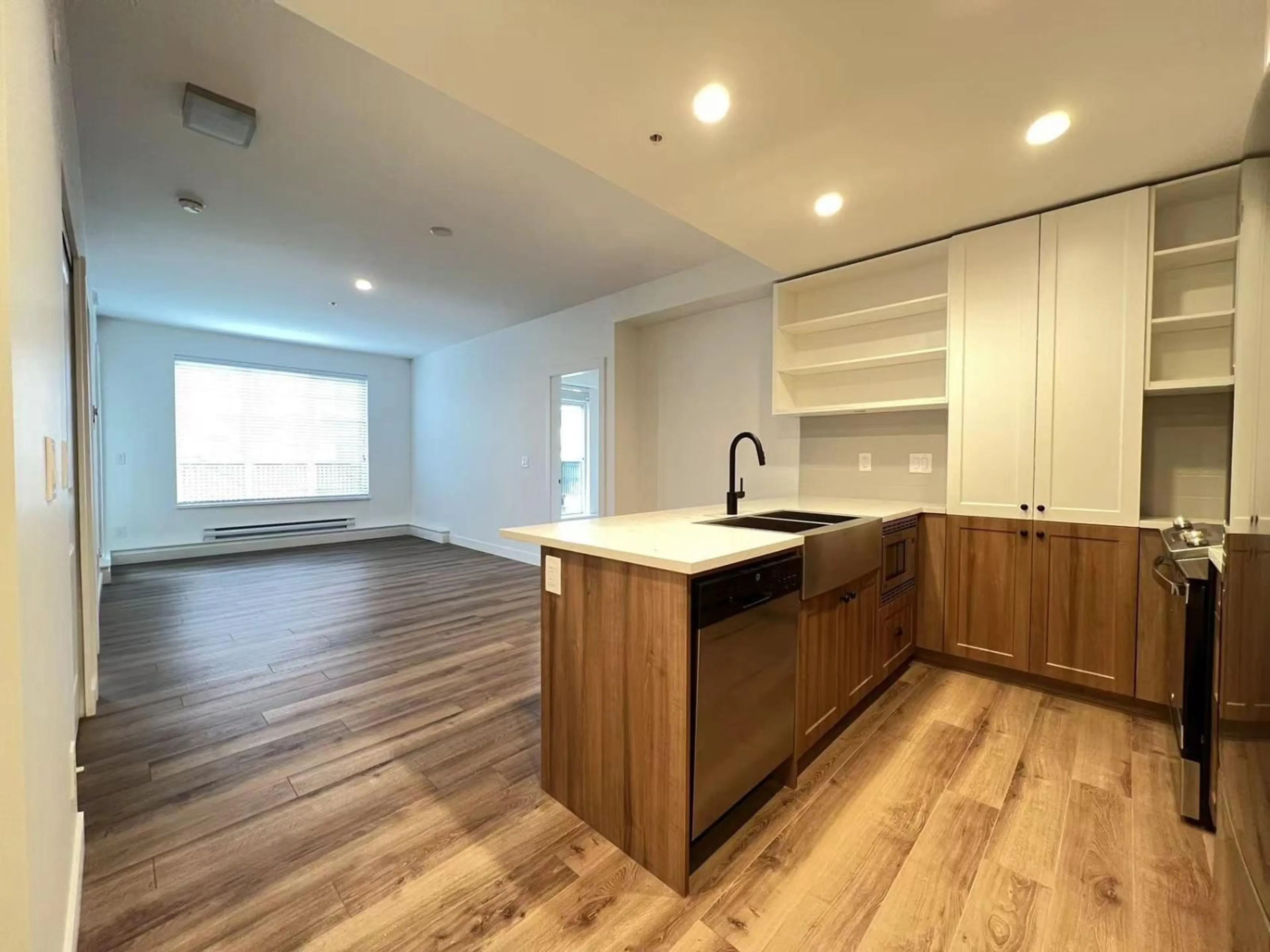 Open concept kitchen, wood/laminate floor for B206 - 20487 65 AVENUE, Langley British Columbia V2Y3K8