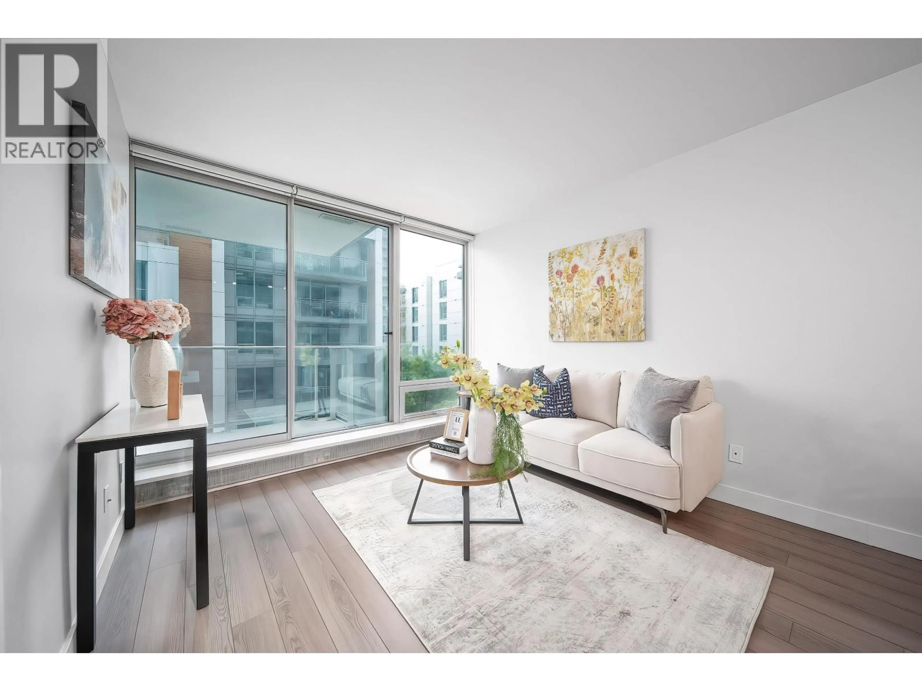 Living room with furniture, wood/laminate floor for 203 - 8031 NUNAVUT LANE, Vancouver British Columbia V5X0C9