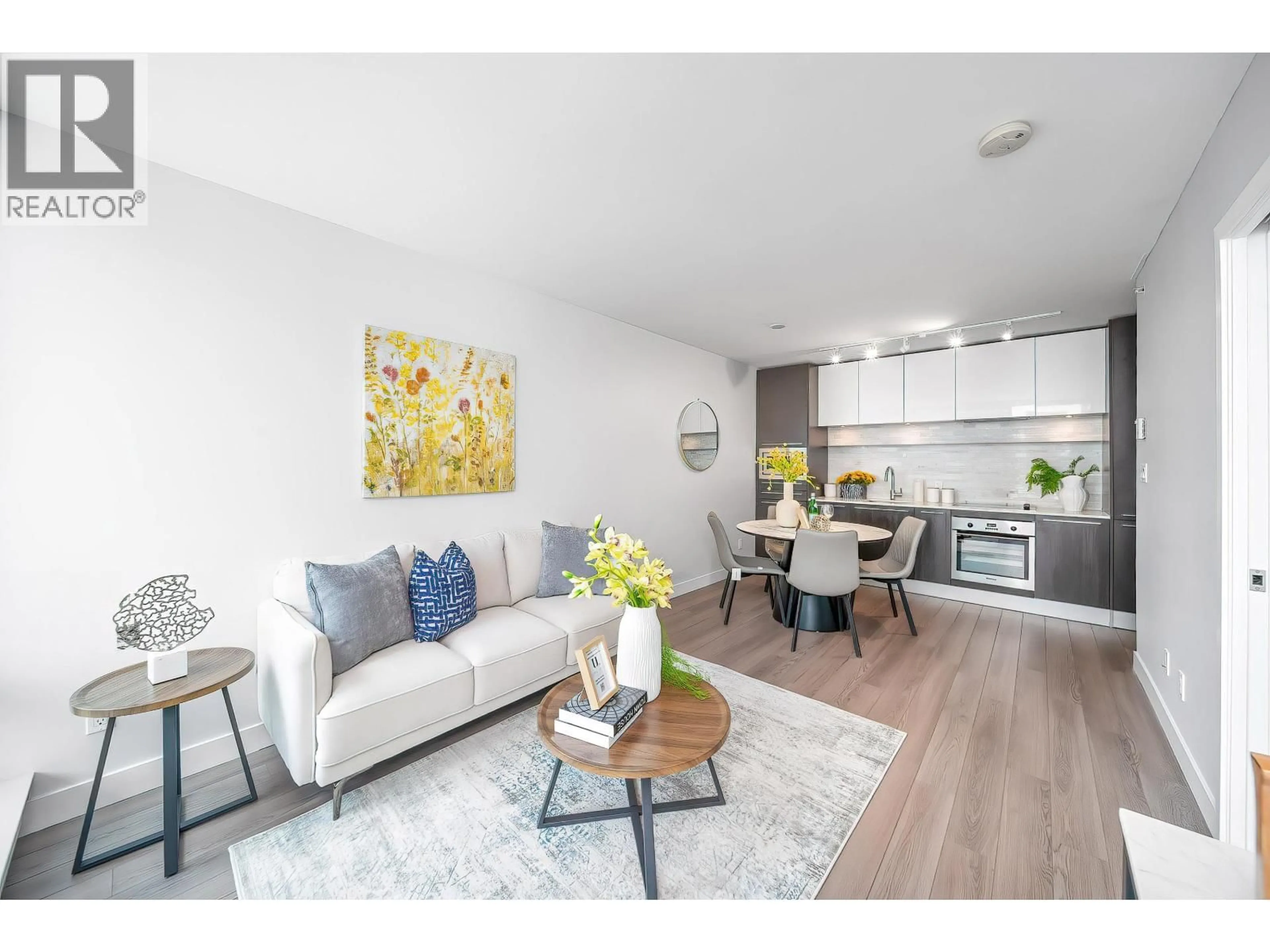 Living room with furniture, wood/laminate floor for 203 - 8031 NUNAVUT LANE, Vancouver British Columbia V5X0C9