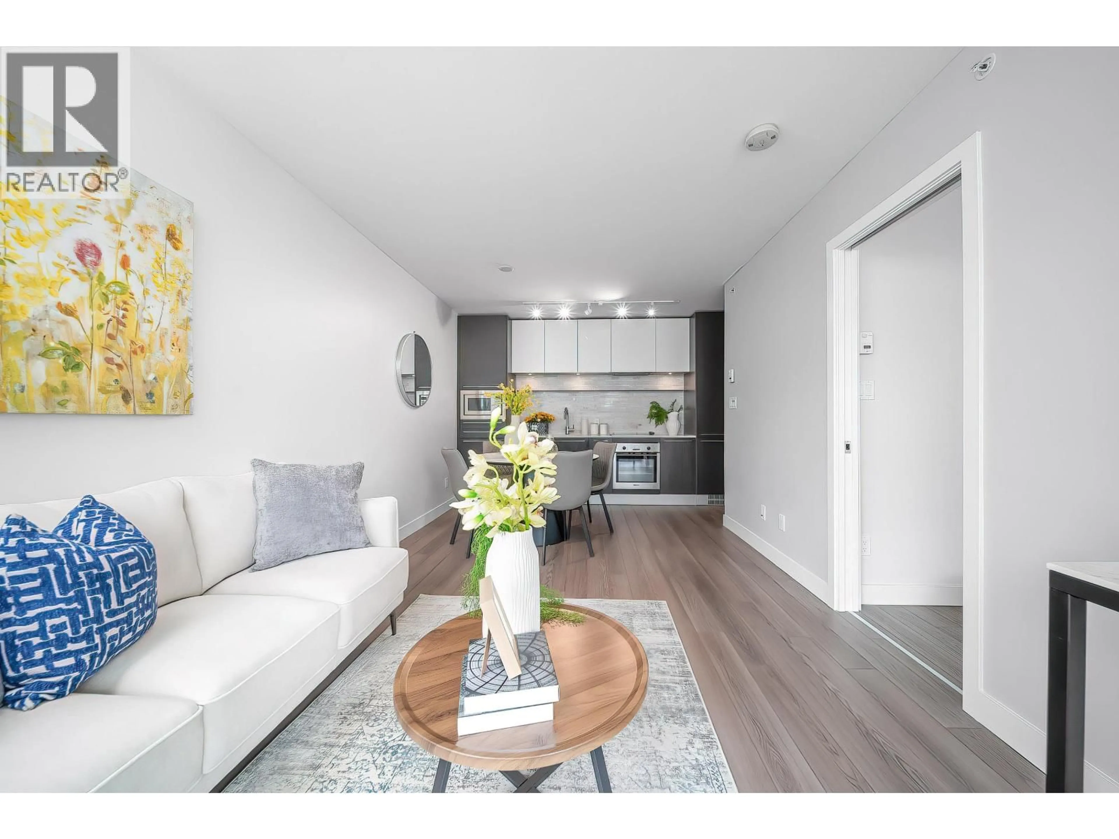 Living room with furniture, wood/laminate floor for 203 - 8031 NUNAVUT LANE, Vancouver British Columbia V5X0C9