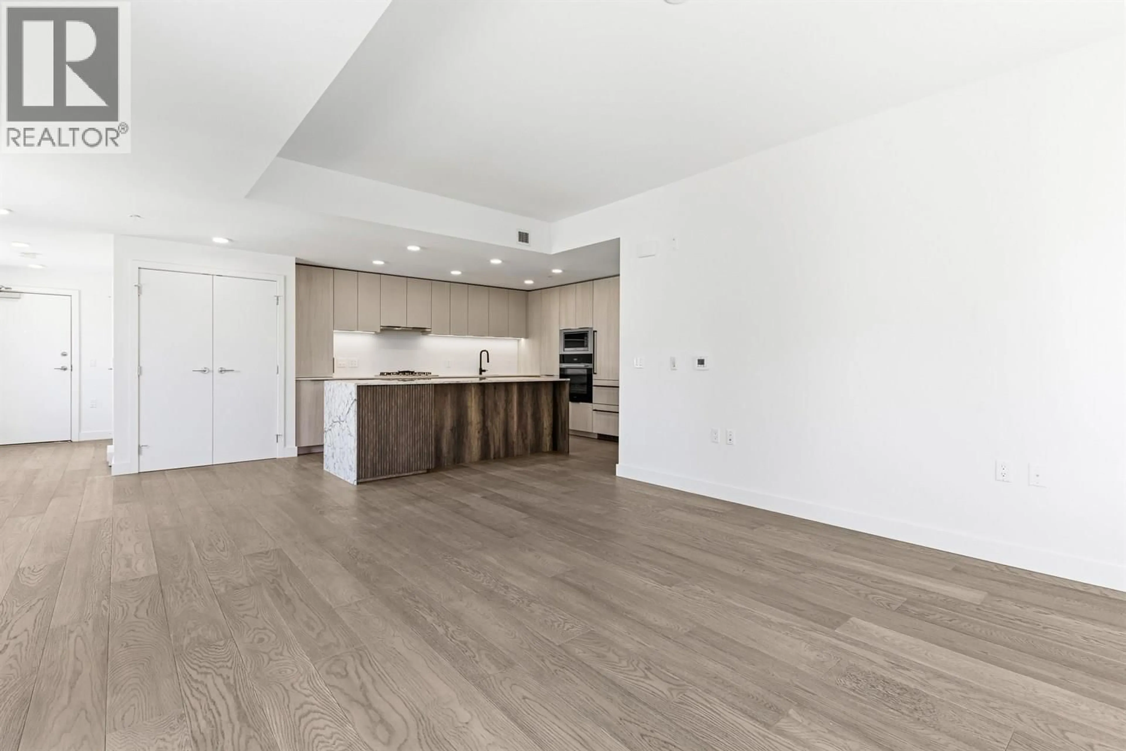 Open concept kitchen, wood/laminate floor for 301 - 3590 39TH AVENUE, Vancouver British Columbia V6N3A5