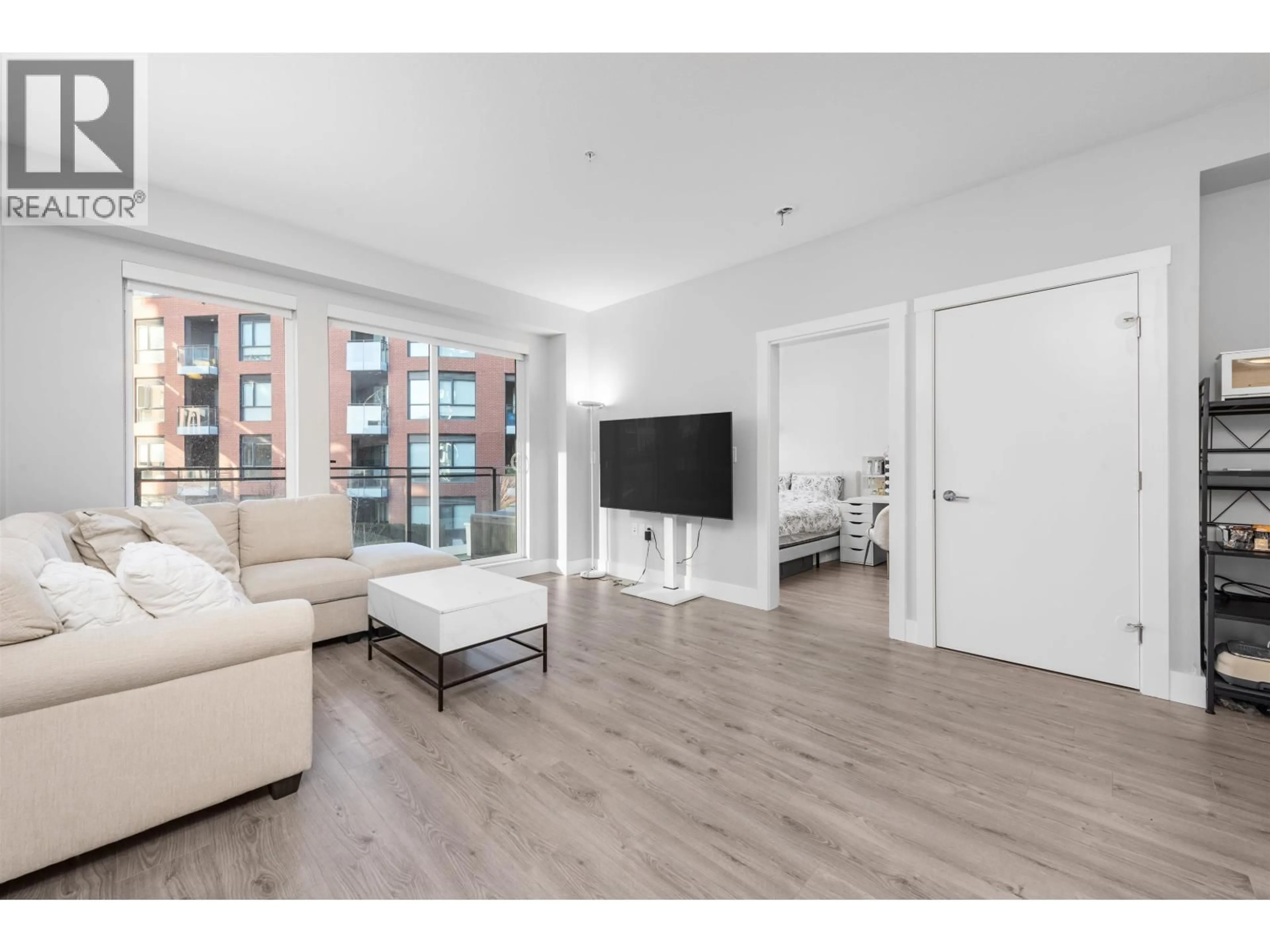 Living room with furniture, wood/laminate floor for 309 - 3588 SAWMILL CRESCENT, Vancouver British Columbia V5S0H5