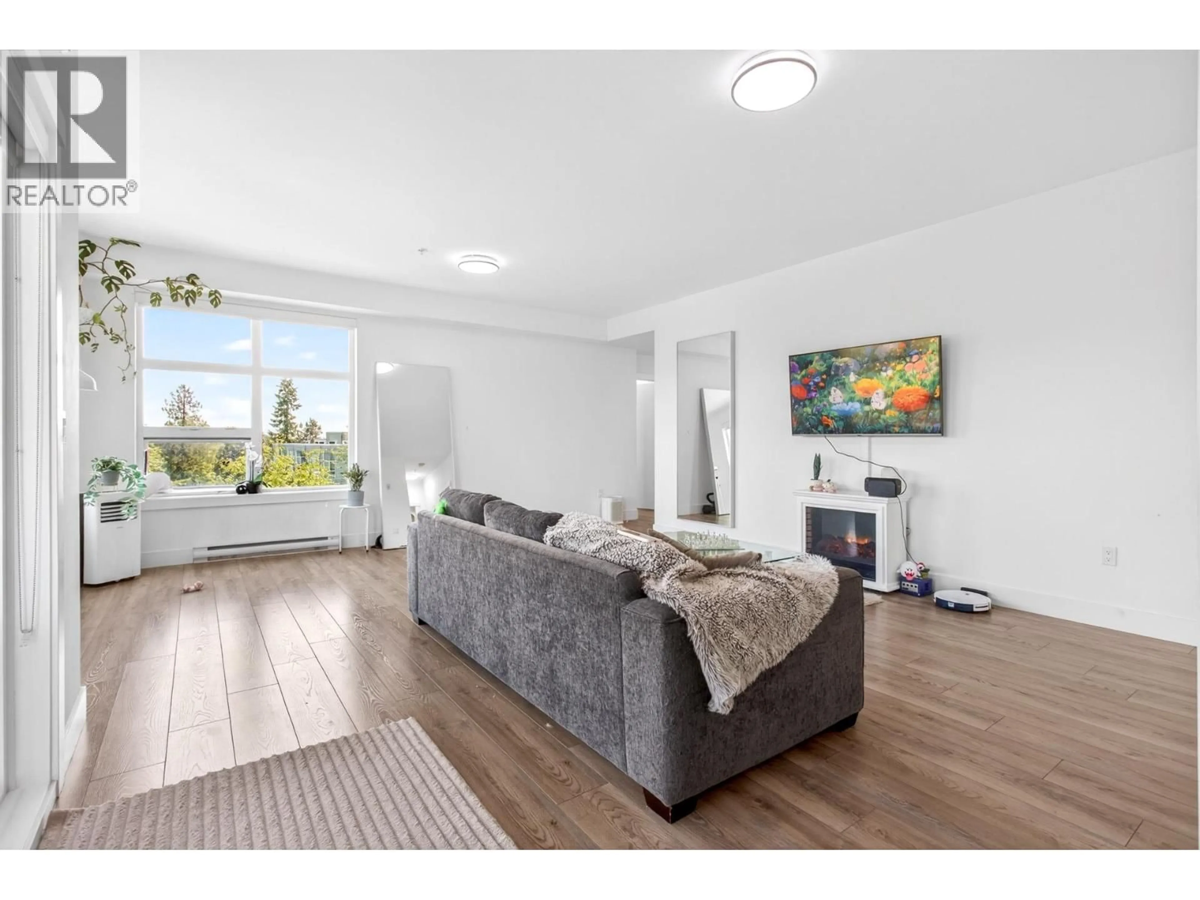 Living room with furniture, wood/laminate floor for 403 - 22577 ROYAL CRESCENT, Maple Ridge British Columbia V2X2M2