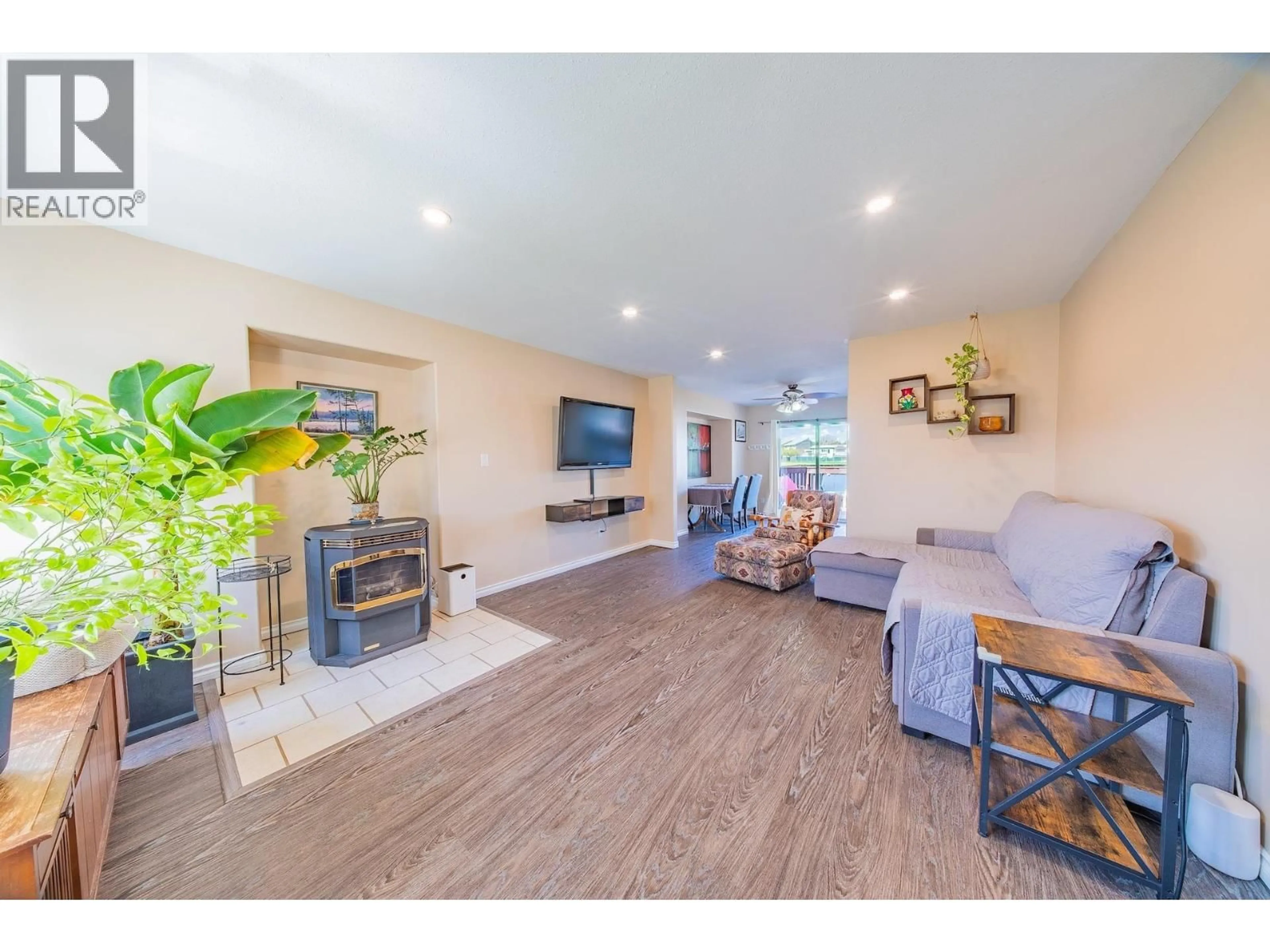 Living room with furniture, wood/laminate floor for 8928 81A STREET, Fort St. John British Columbia V1J6X7