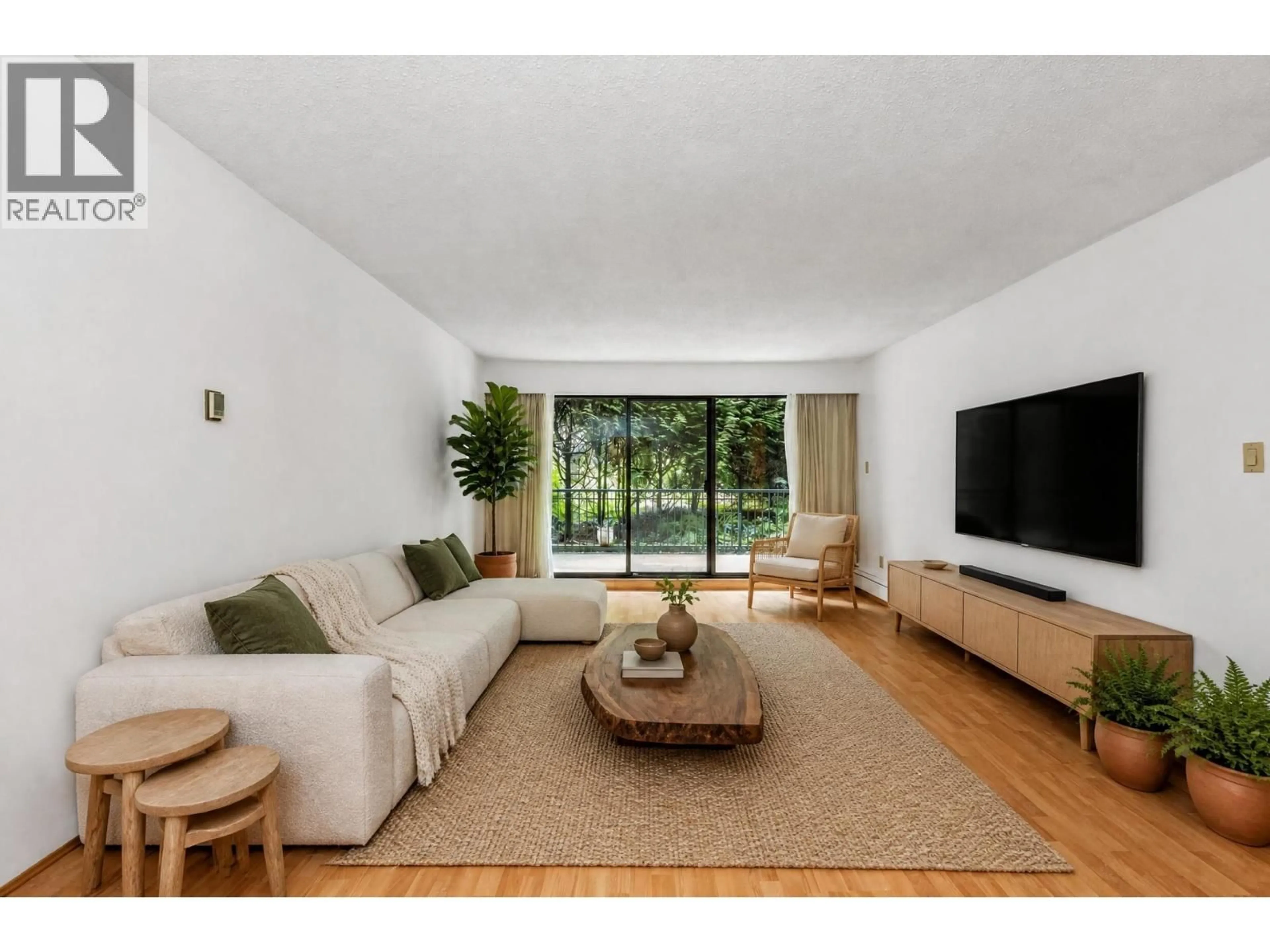 Living room with furniture, wood/laminate floor for 219 - 1385 DRAYCOTT ROAD, North Vancouver British Columbia V7J3K9