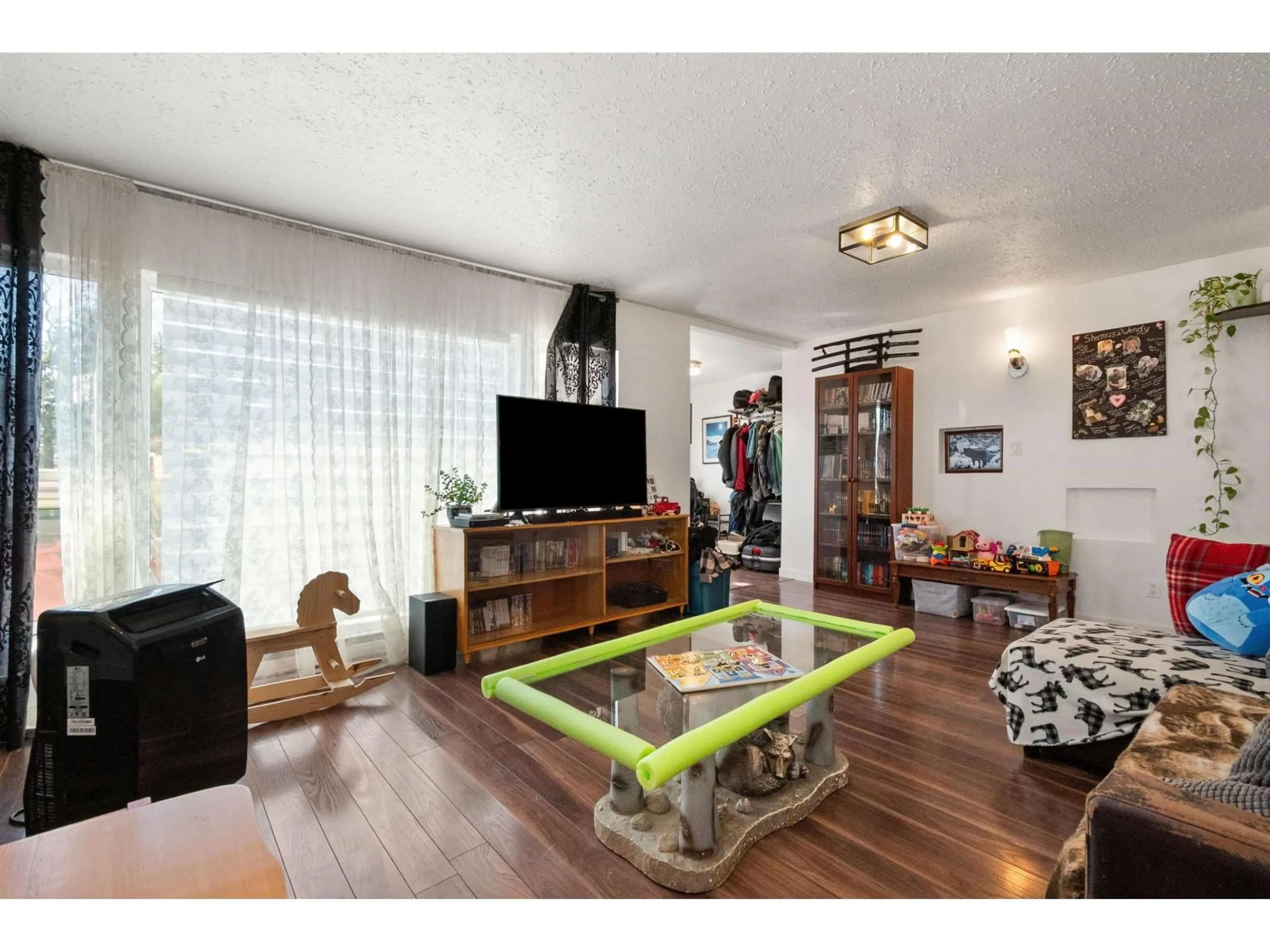 Living room with furniture, wood/laminate floor for 41023 YALE ROAD, Chilliwack British Columbia V2R4J2