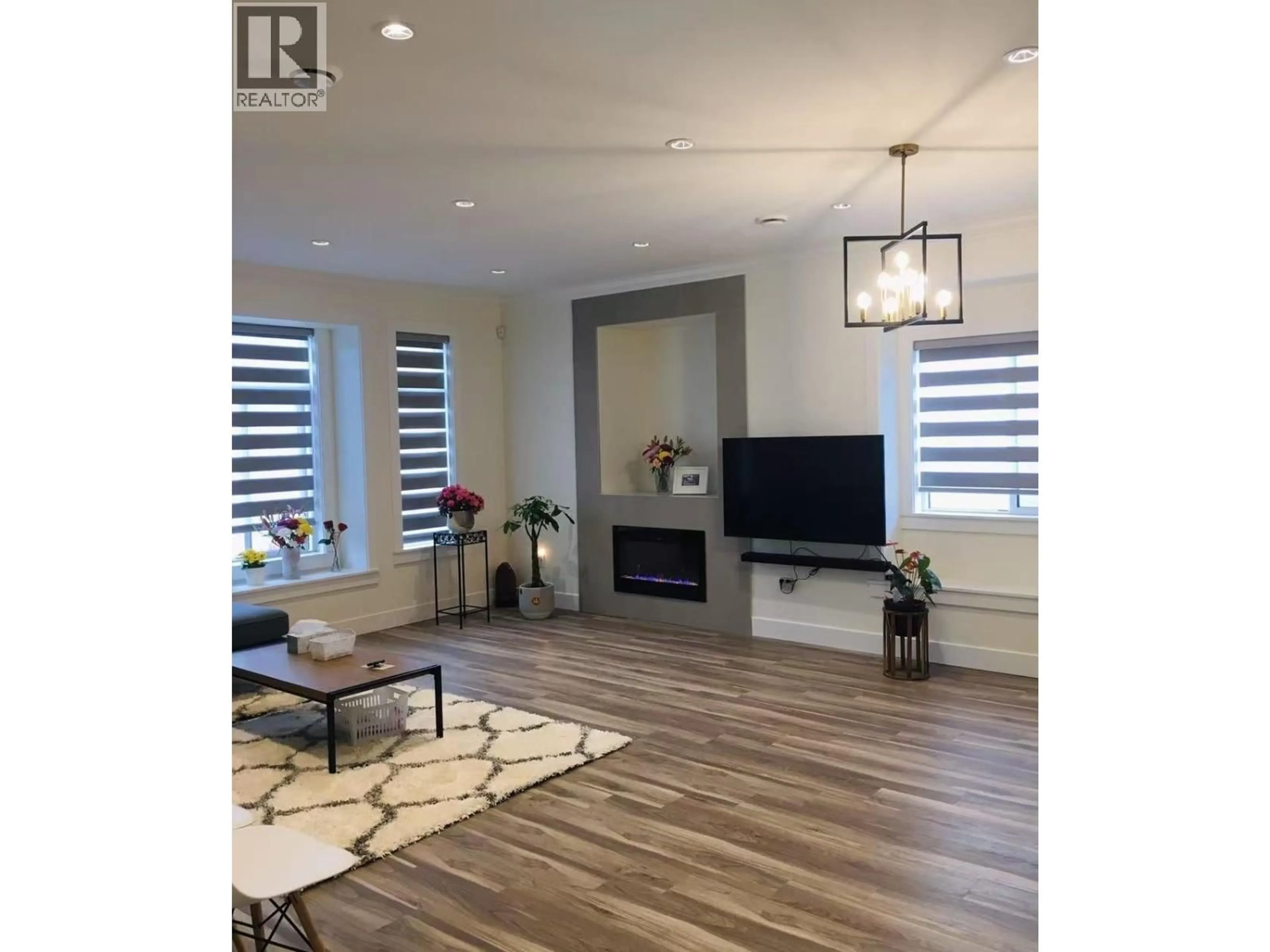 Living room with furniture, wood/laminate floor for 2822 GLEN DRIVE, Coquitlam British Columbia V3B0A4