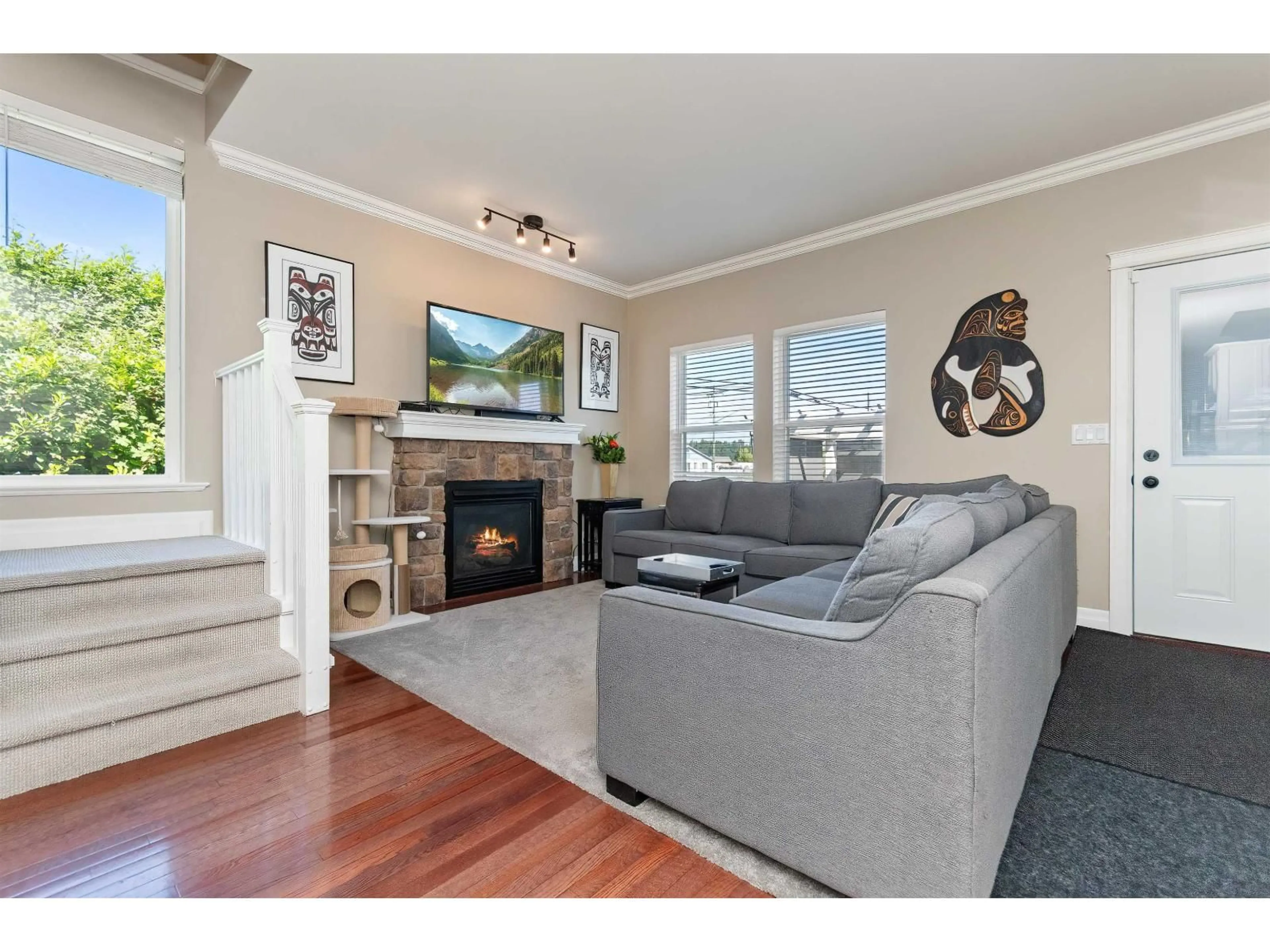 Living room with furniture, wood/laminate floor for 34609 7 AVENUE, Abbotsford British Columbia V2S8P4