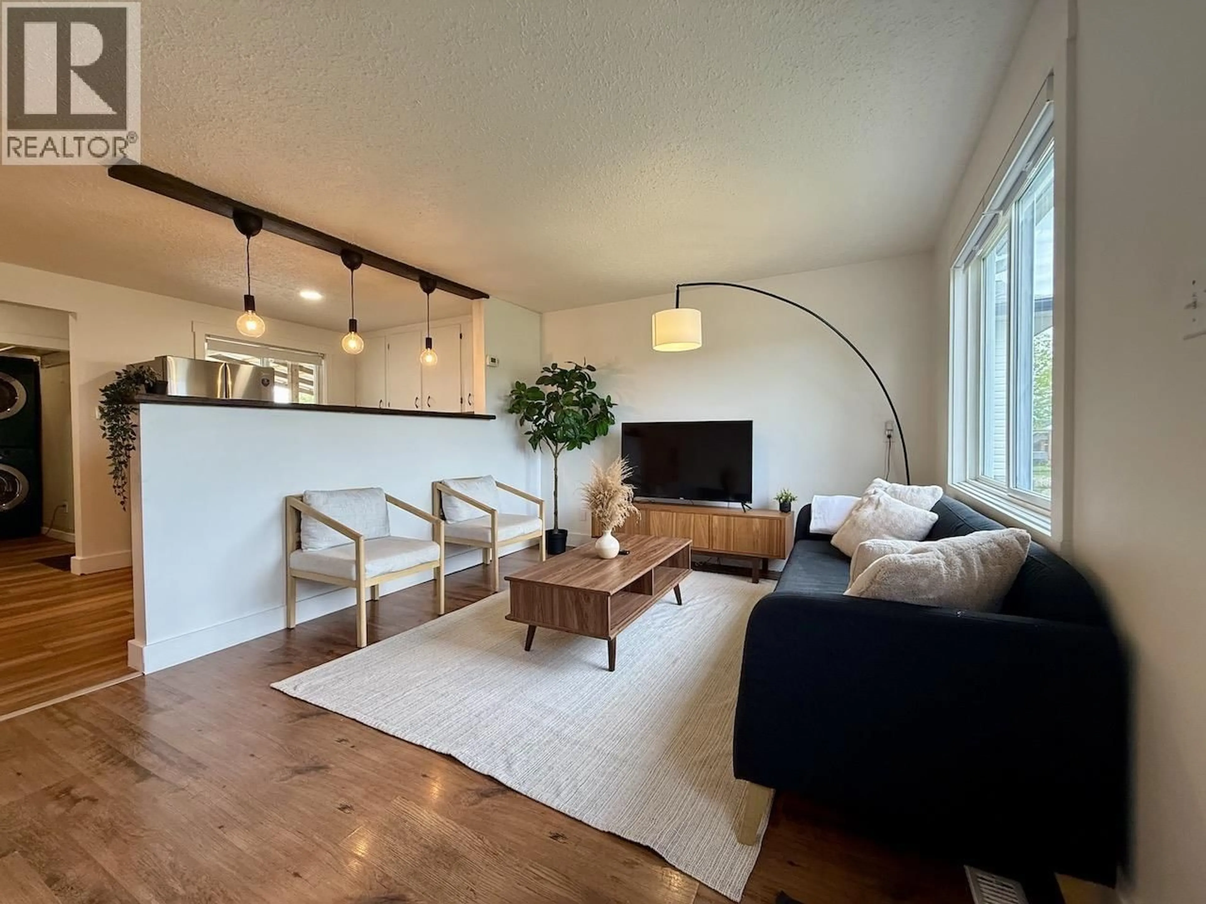 Living room with furniture, wood/laminate floor for 8807 78A STREET, Fort St. John British Columbia V1J3B3