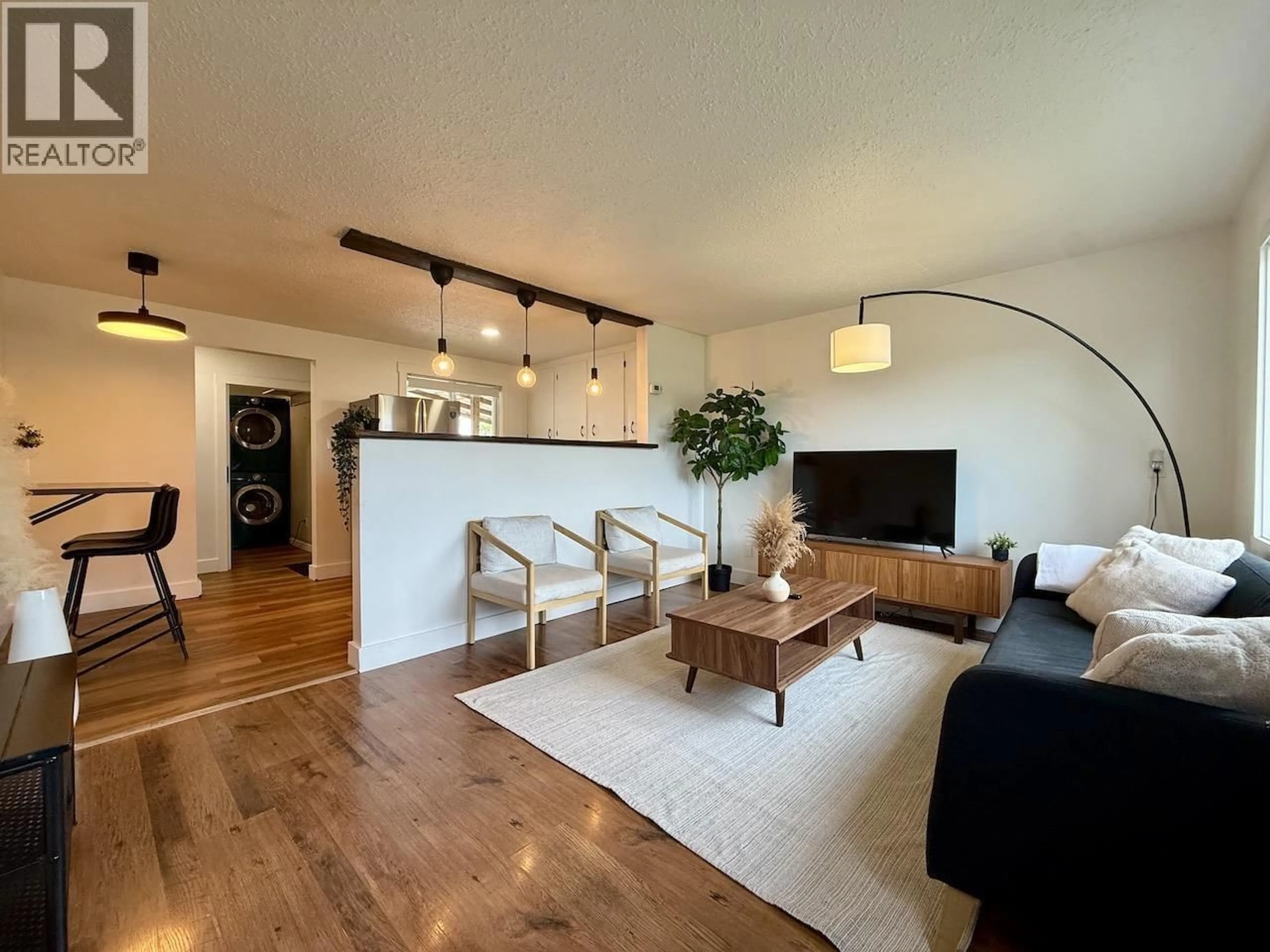 Living room with furniture, wood/laminate floor for 8807 78A STREET, Fort St. John British Columbia V1J3B3