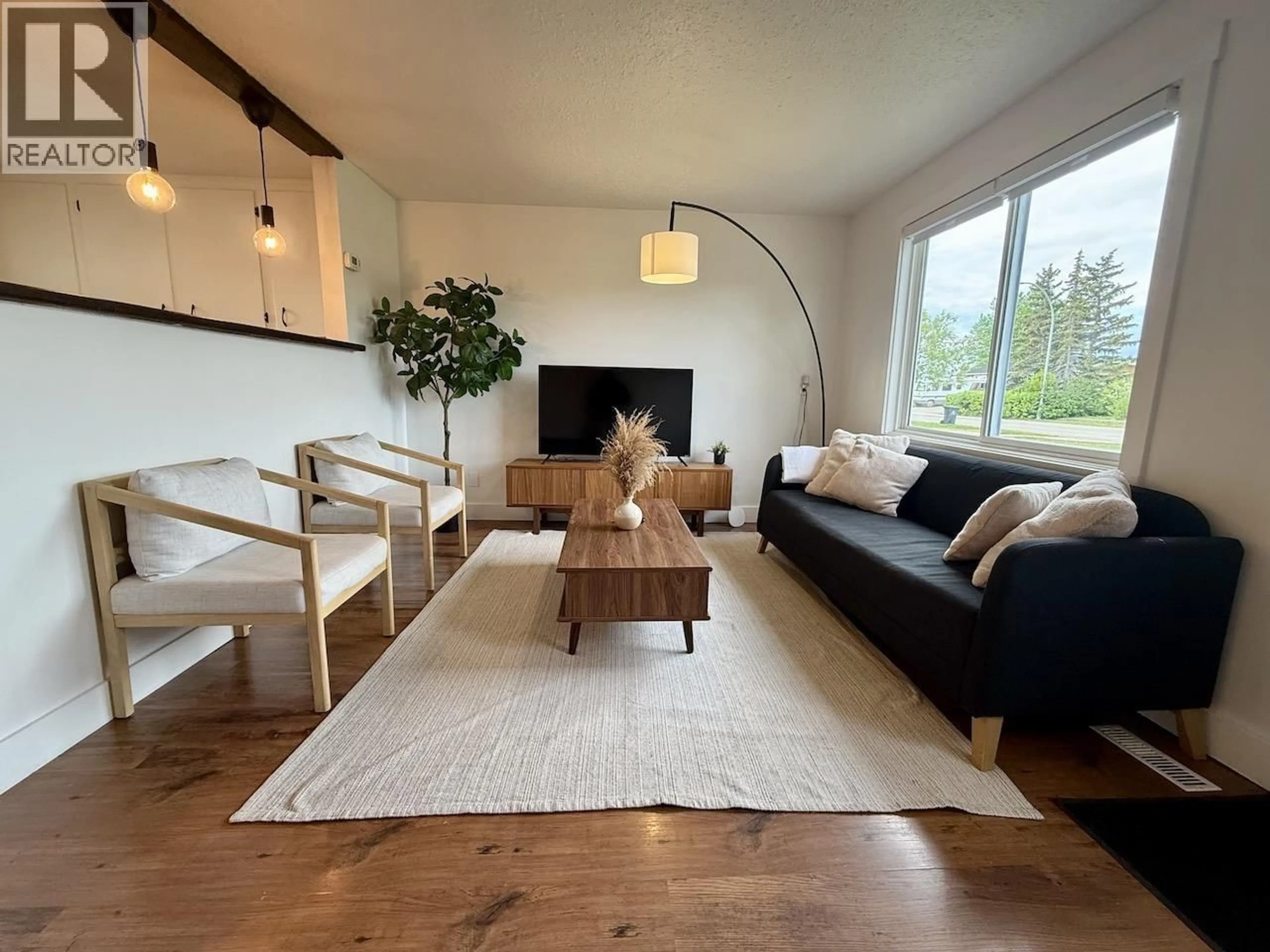 Living room with furniture, wood/laminate floor for 8807 78A STREET, Fort St. John British Columbia V1J3B3