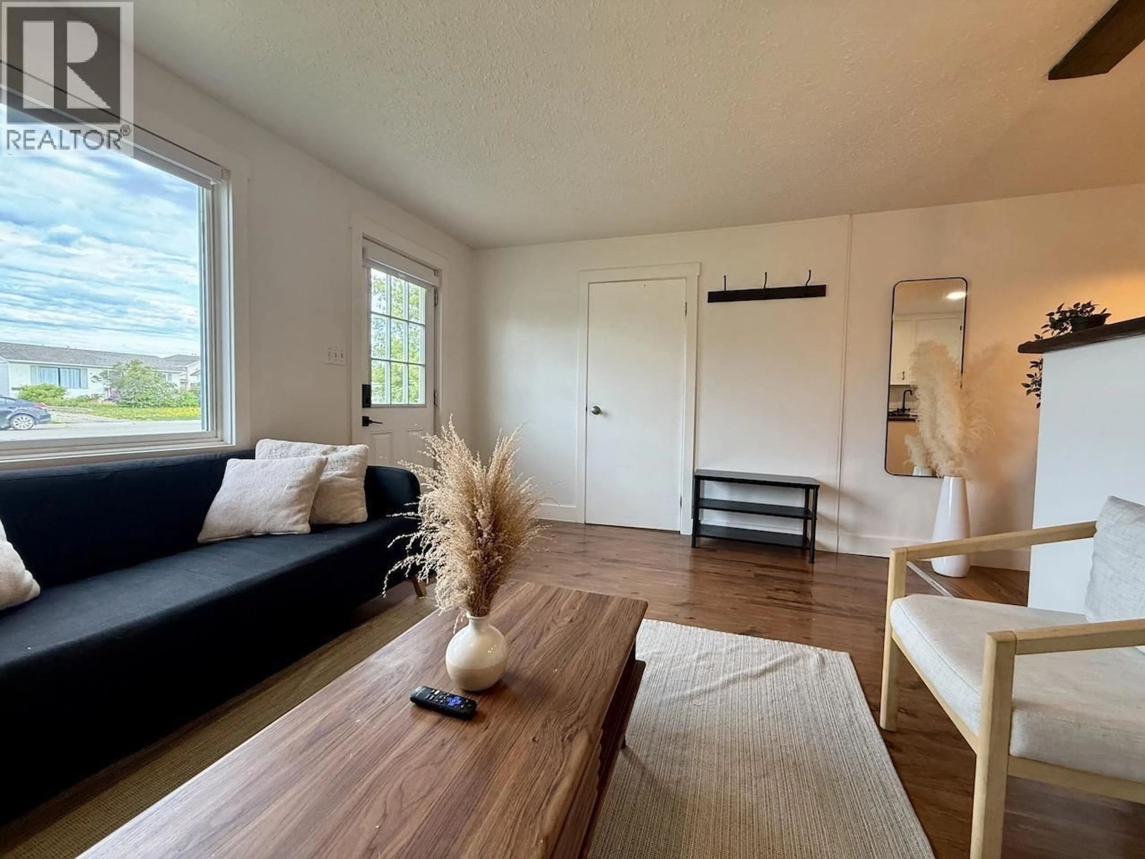 Living room with furniture, wood/laminate floor for 8807 78A STREET, Fort St. John British Columbia V1J3B3