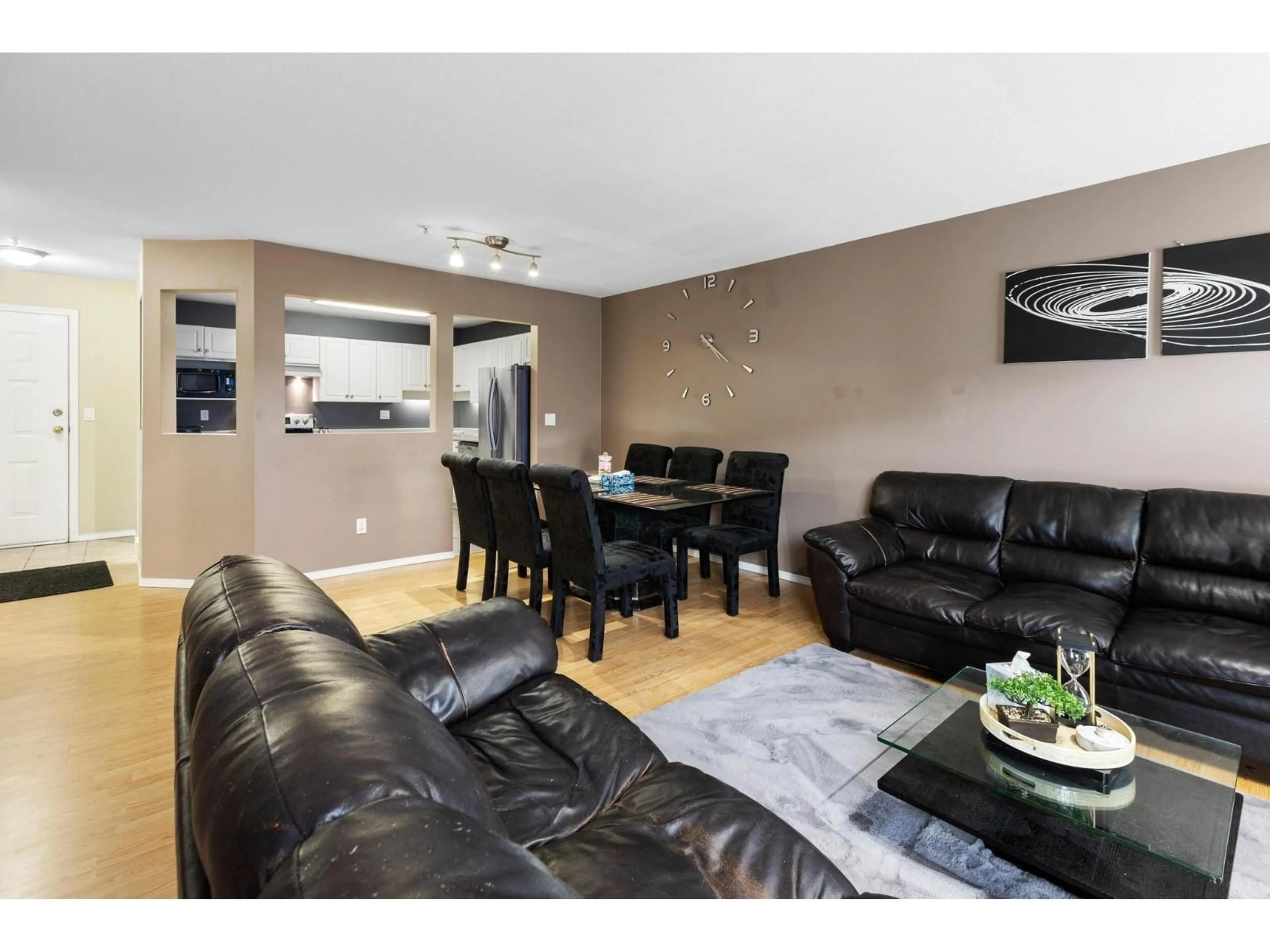 Living room with furniture, wood/laminate floor for 305 - 31831 PEARDONVILLE ROAD, Abbotsford British Columbia V2T1L5