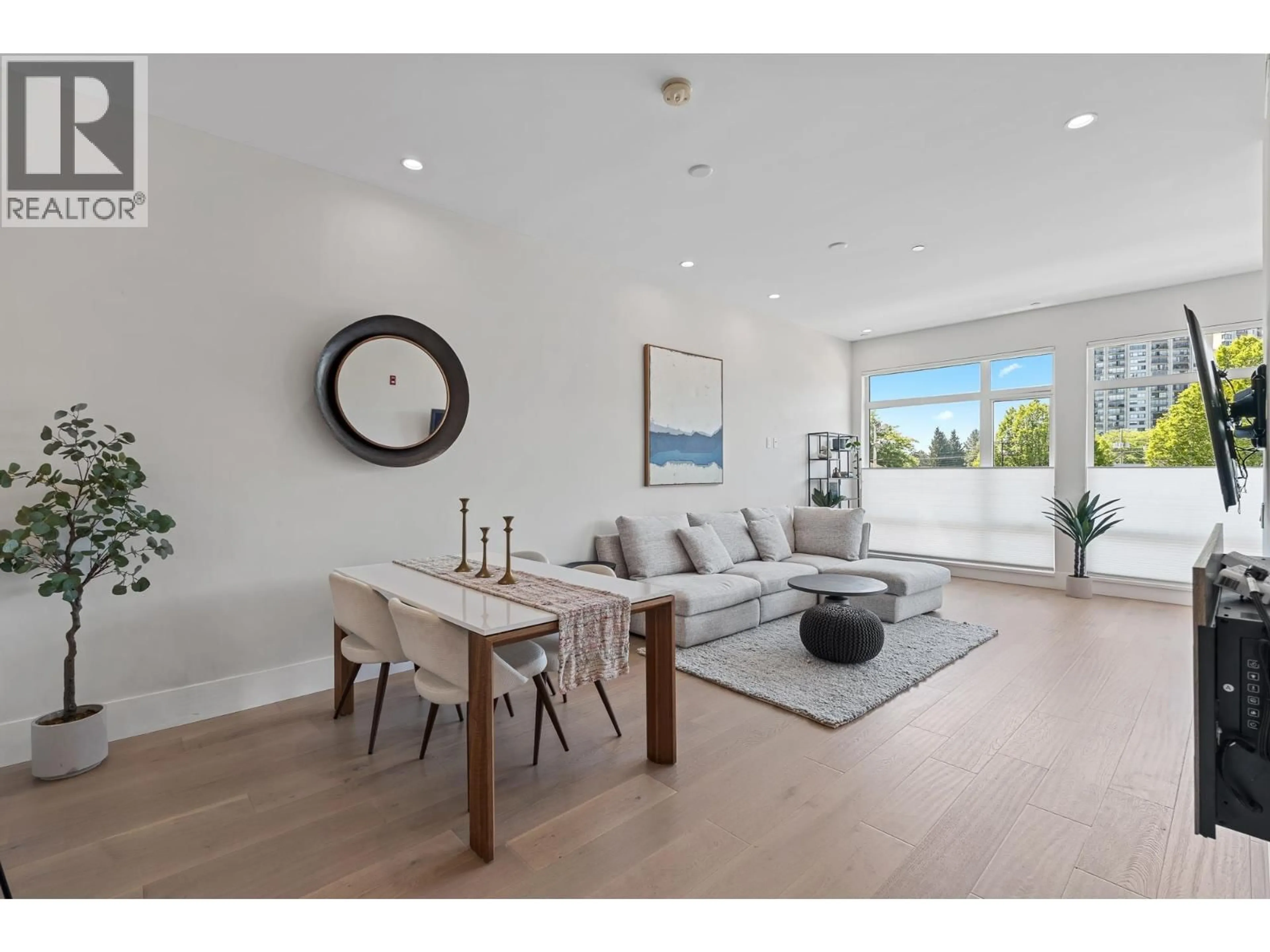 Living room with furniture, wood/laminate floor for 206 - 1591 BOWSER AVENUE, North Vancouver British Columbia V7P2Y4