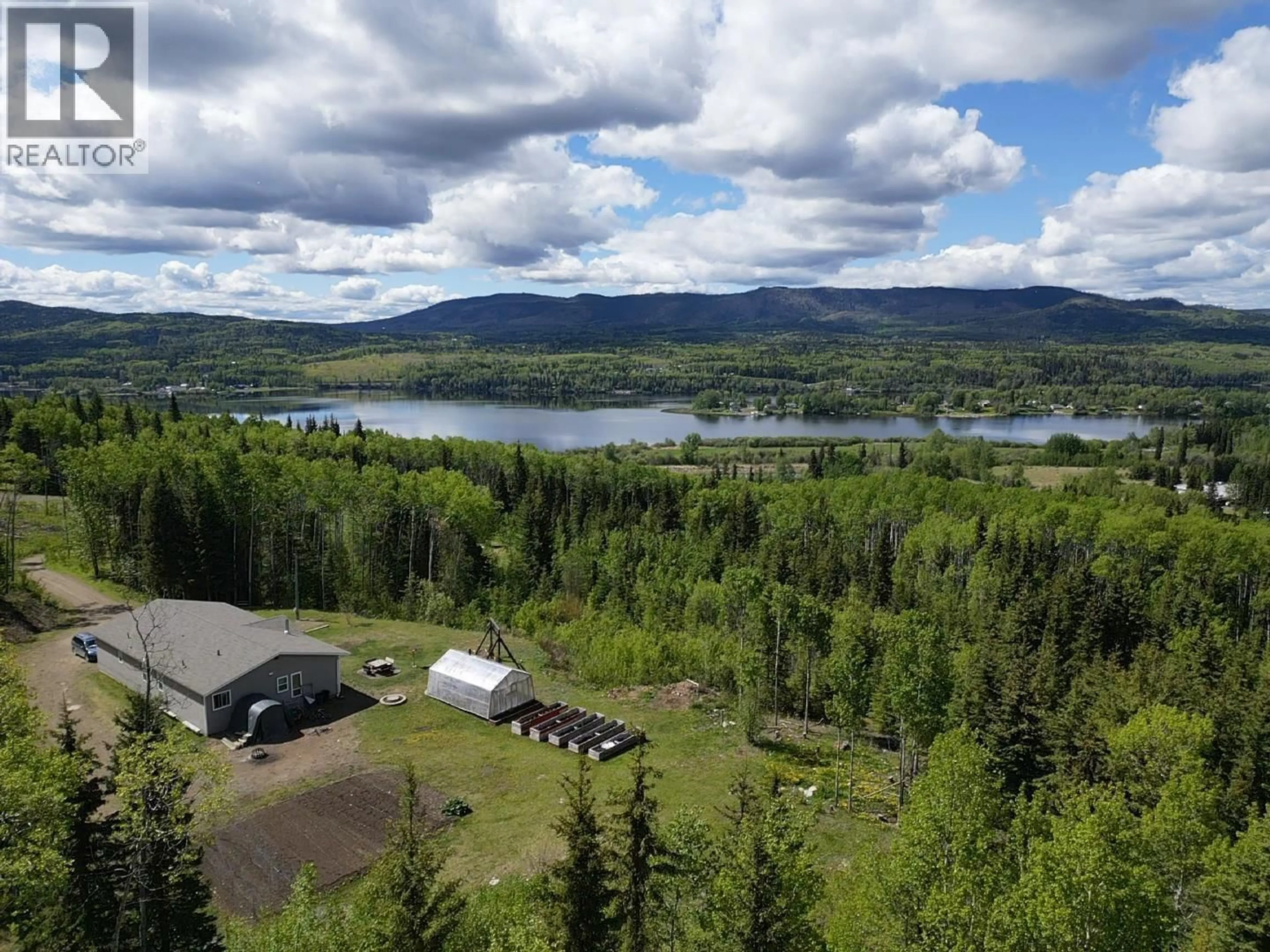 A pic from outside/outdoor area/front of a property/back of a property/a pic from drone, water/lake/river/ocean view for 100 SCHRITT CRESCENT, Burns Lake British Columbia V0J1E0