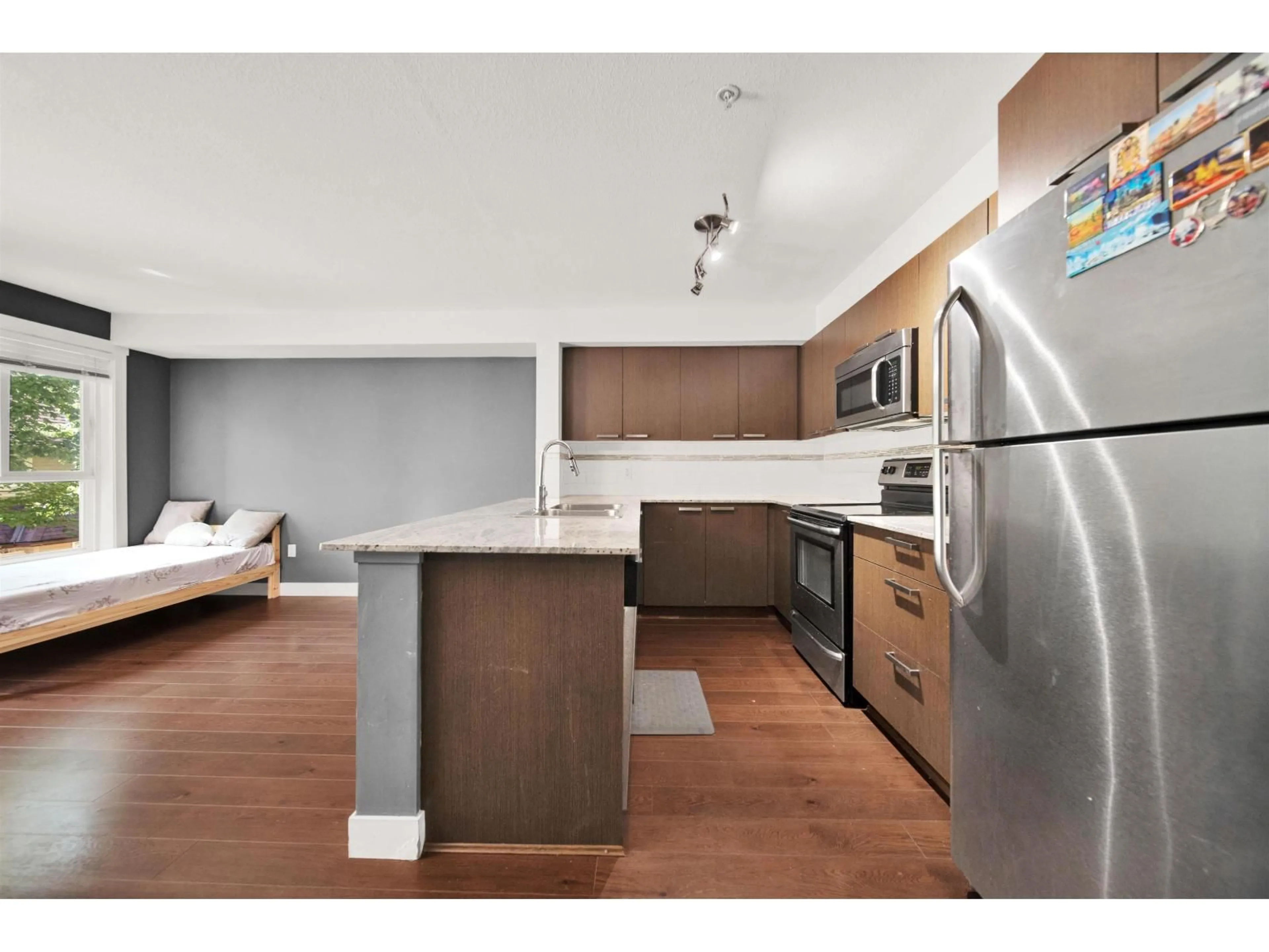 Open concept kitchen, wood/laminate floor for 201 - 13883 LAUREL DRIVE, Surrey British Columbia V3T1A8