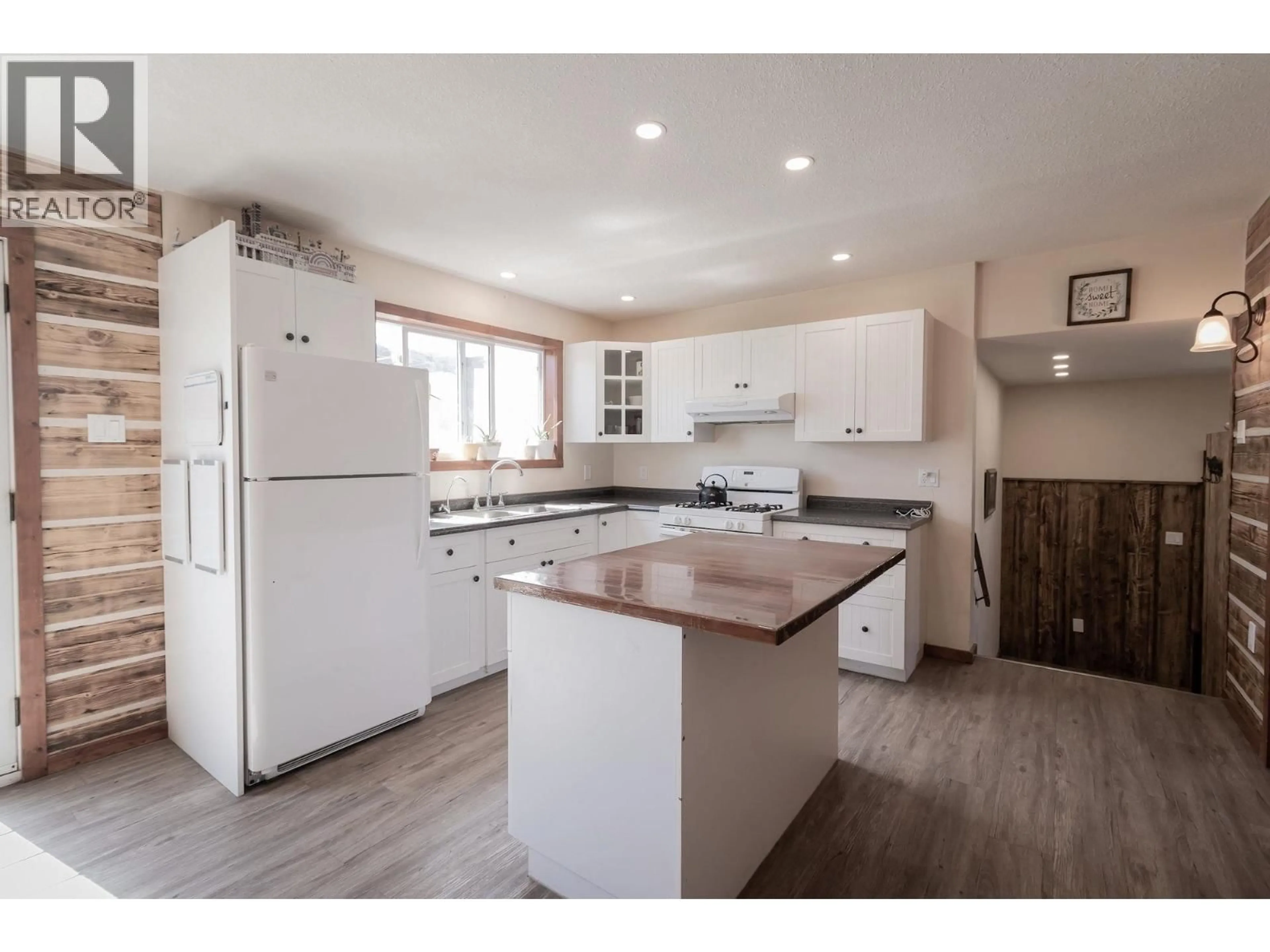 Open concept kitchen, wood/laminate floor for 1016 240 ROAD, Fort St. John British Columbia V0C1K0