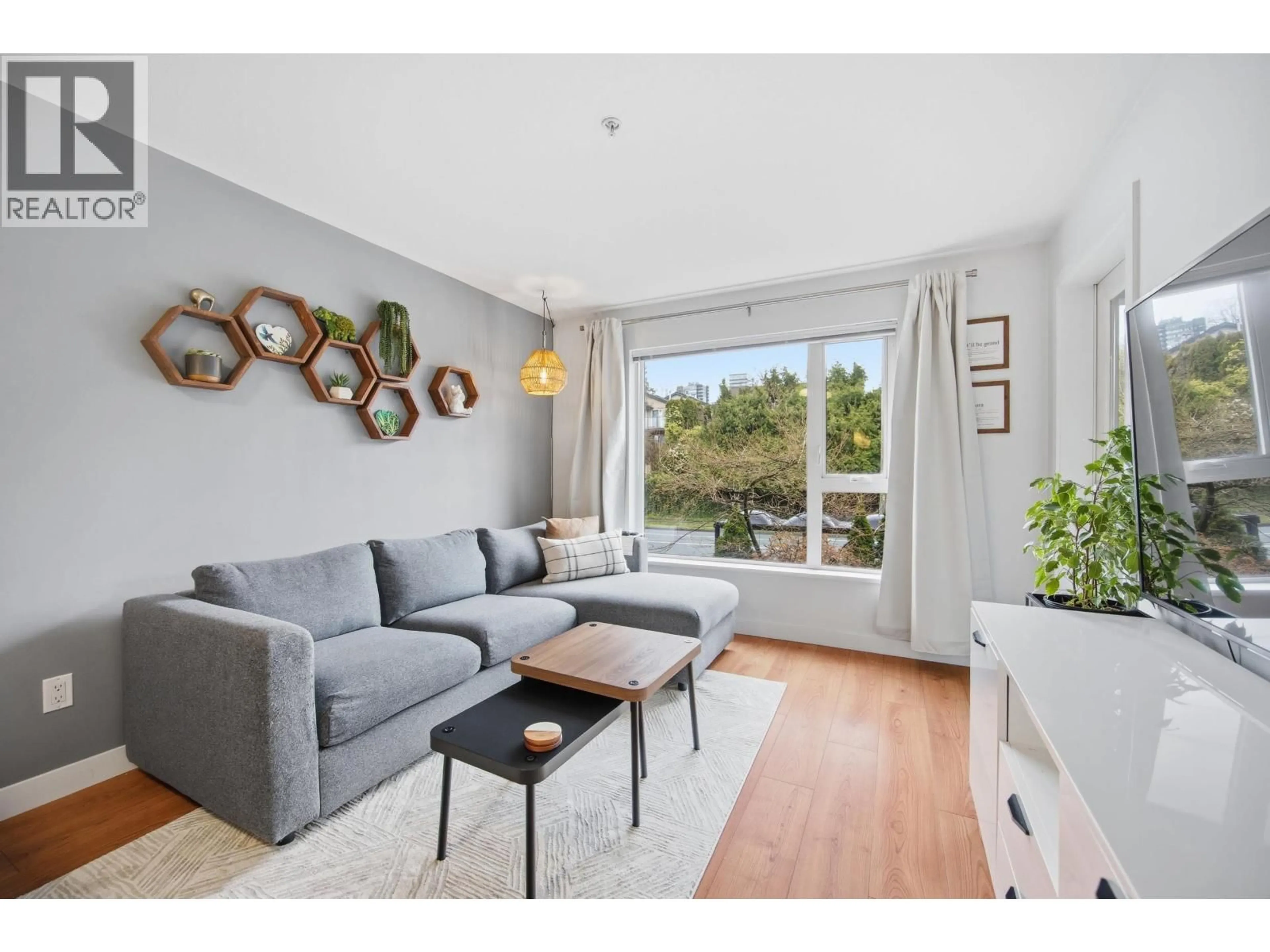 Living room with furniture, wood/laminate floor for 209 - 221 3RD STREET, North Vancouver British Columbia V7L0C1