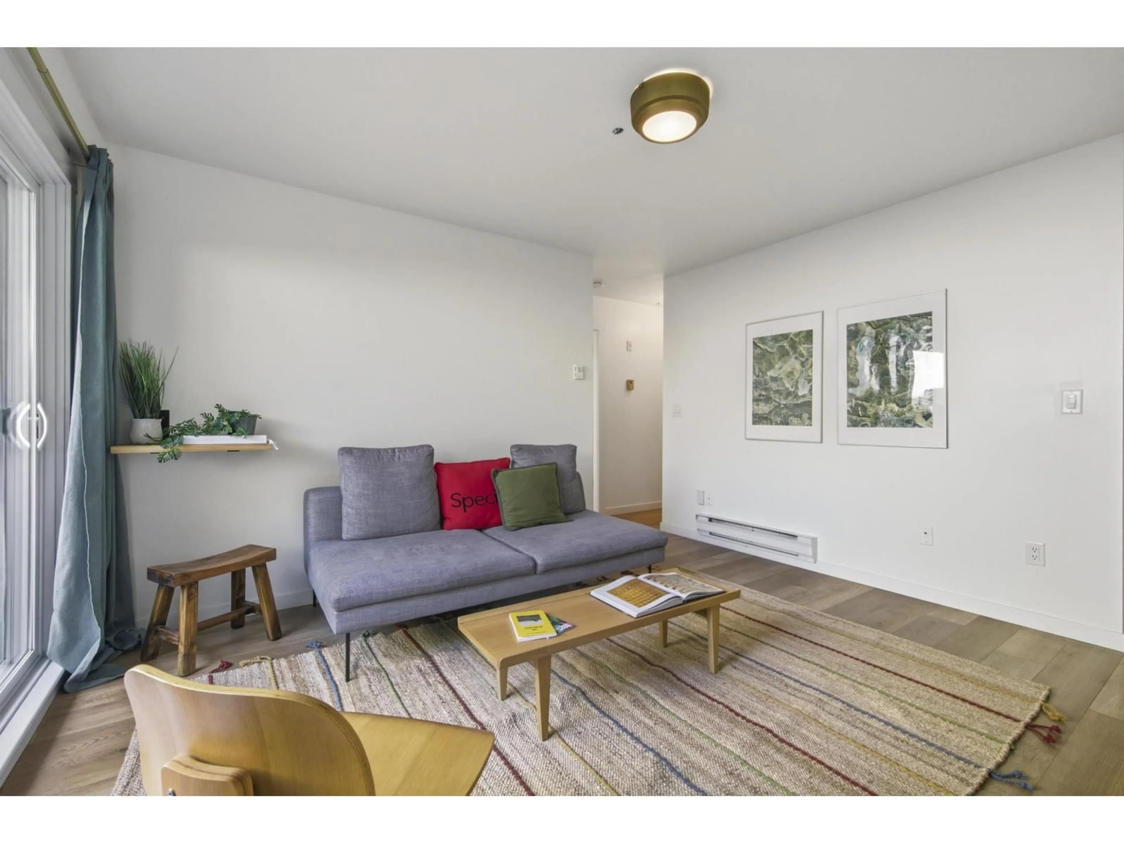 Living room with furniture, wood/laminate floor for 205 - 33165 2ND AVENUE, Mission British Columbia V2V6T8
