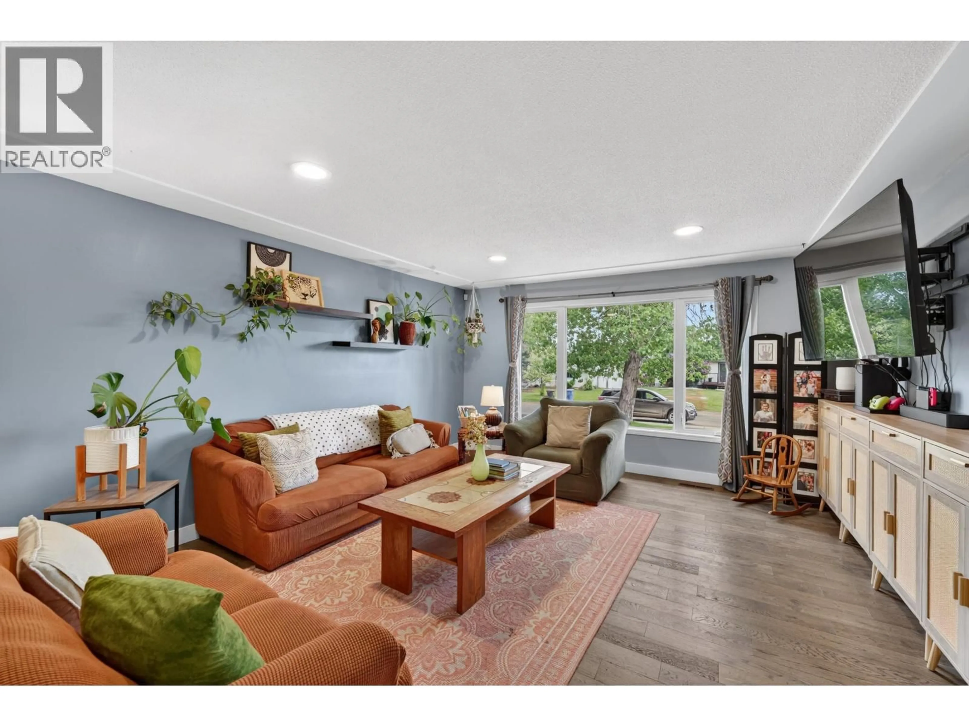Living room with furniture, wood/laminate floor for 10315 111 AVENUE, Fort St. John British Columbia V1J2V3