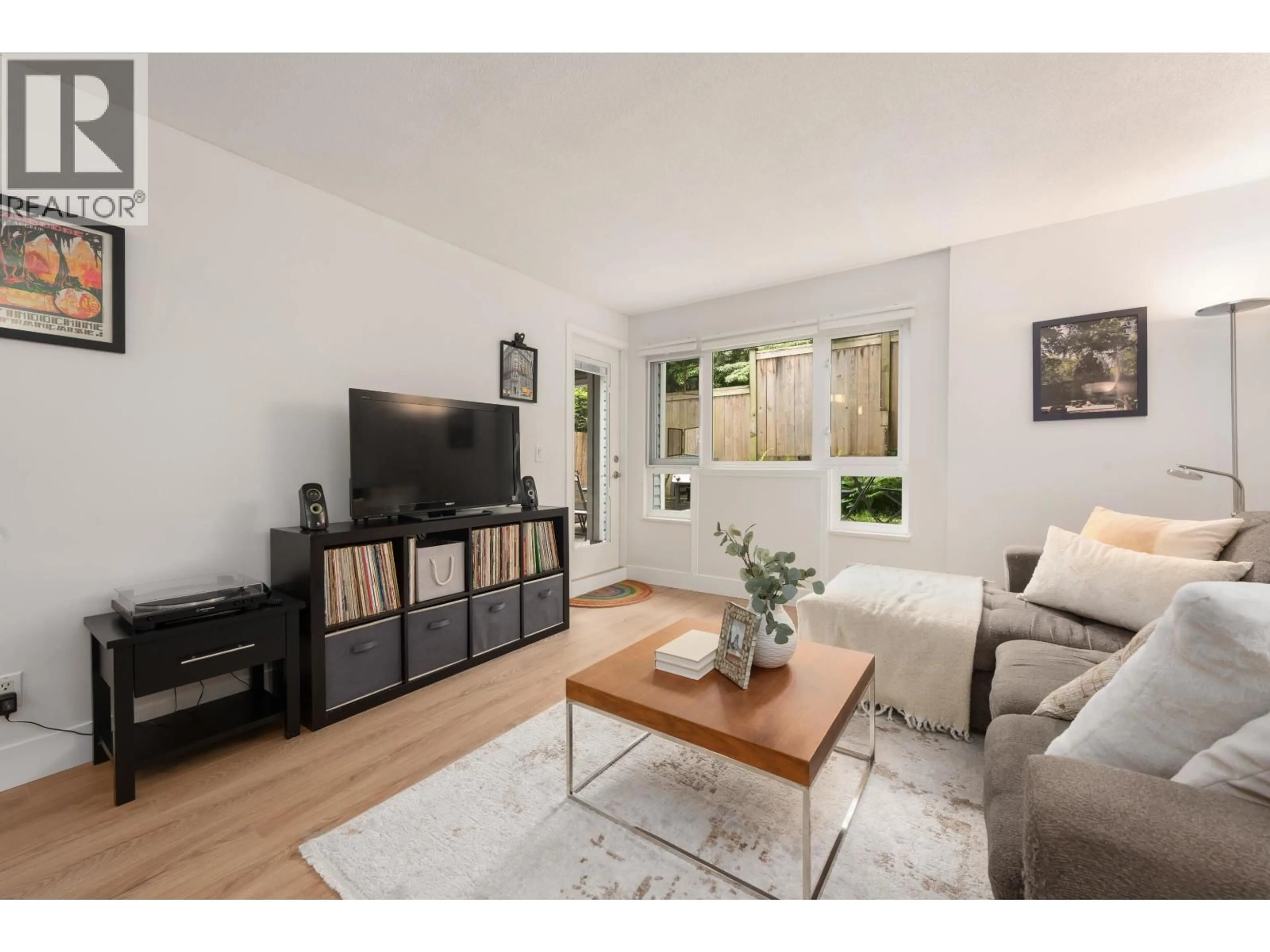 Living room with furniture, wood/laminate floor for 104 - 1330 GRAVELEY STREET, Vancouver British Columbia V5L3A2