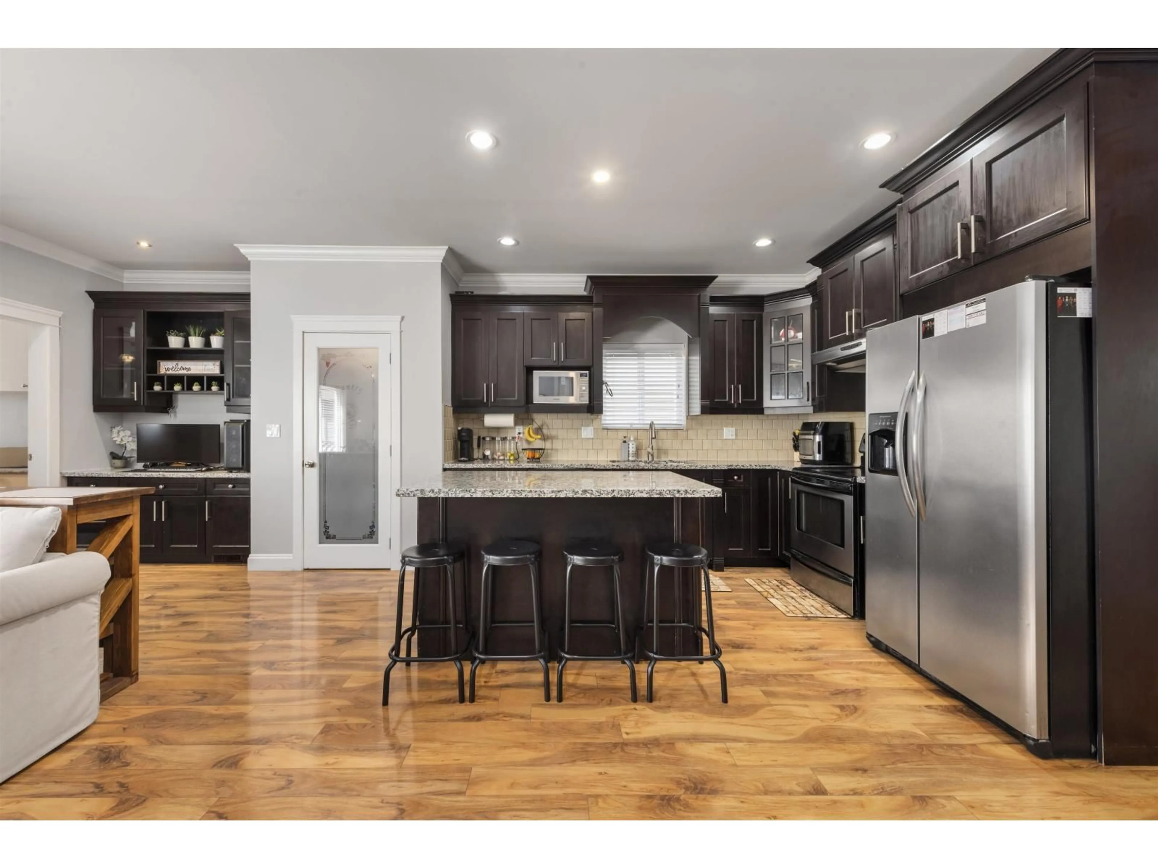 Open concept kitchen, wood/laminate floor for 15032 60 AVENUE, Surrey British Columbia V3S5X6