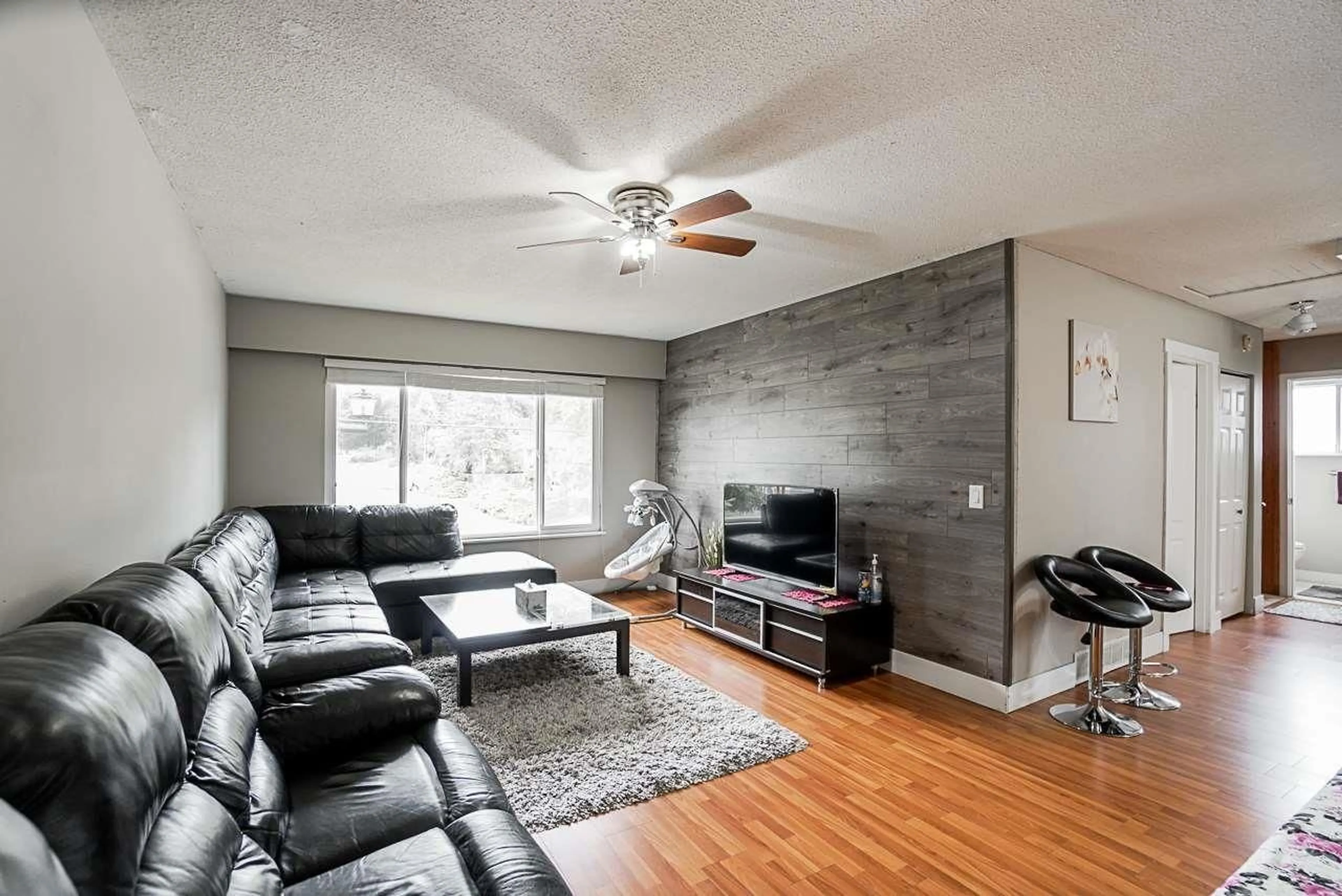 Living room with furniture, wood/laminate floor for 17954 58 AVENUE, Surrey British Columbia V3S1L7