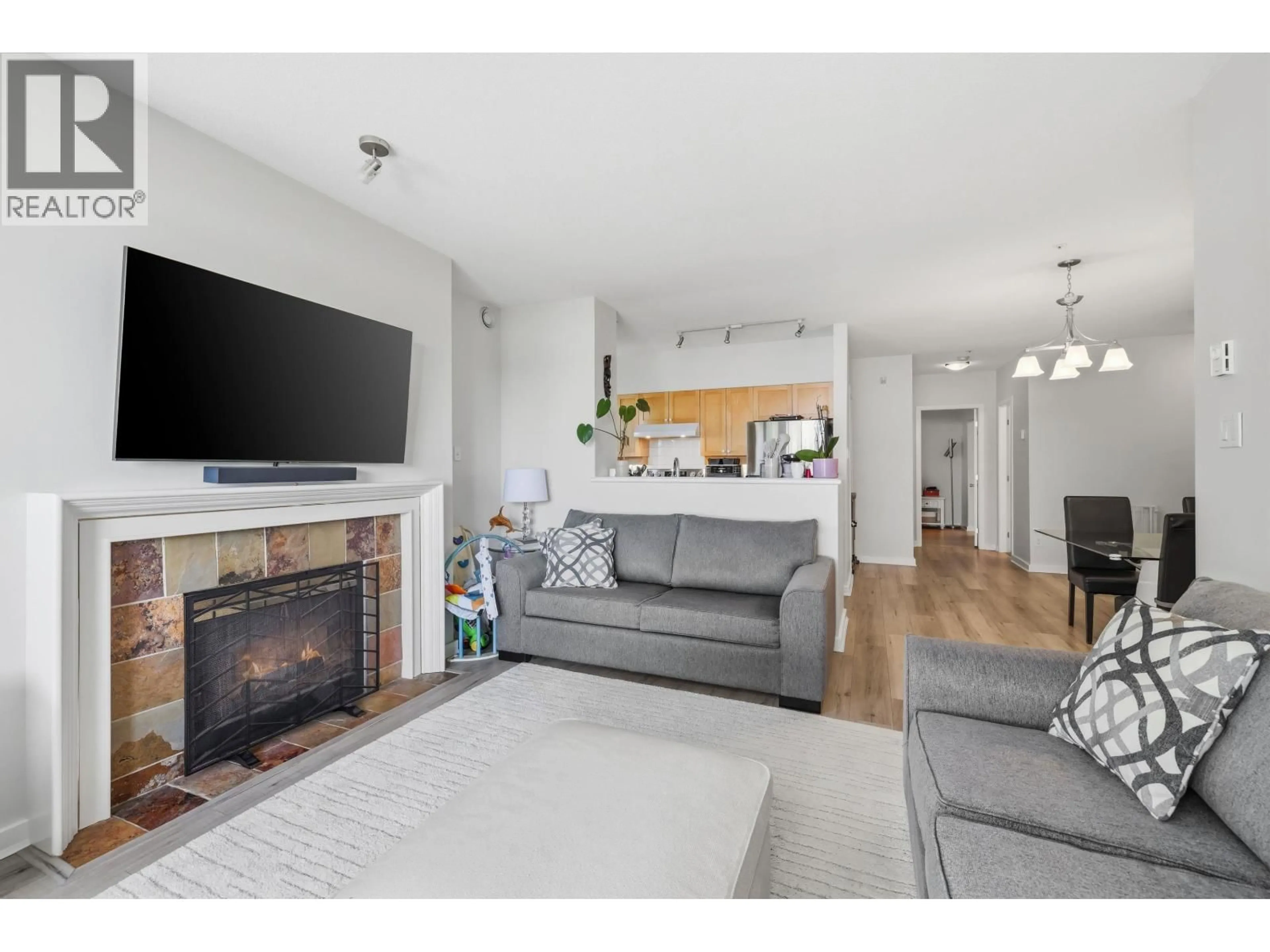 Living room with furniture, wood/laminate floor for 104 - 2080 KENT SOUTH AVENUE, Vancouver British Columbia V5P4X2